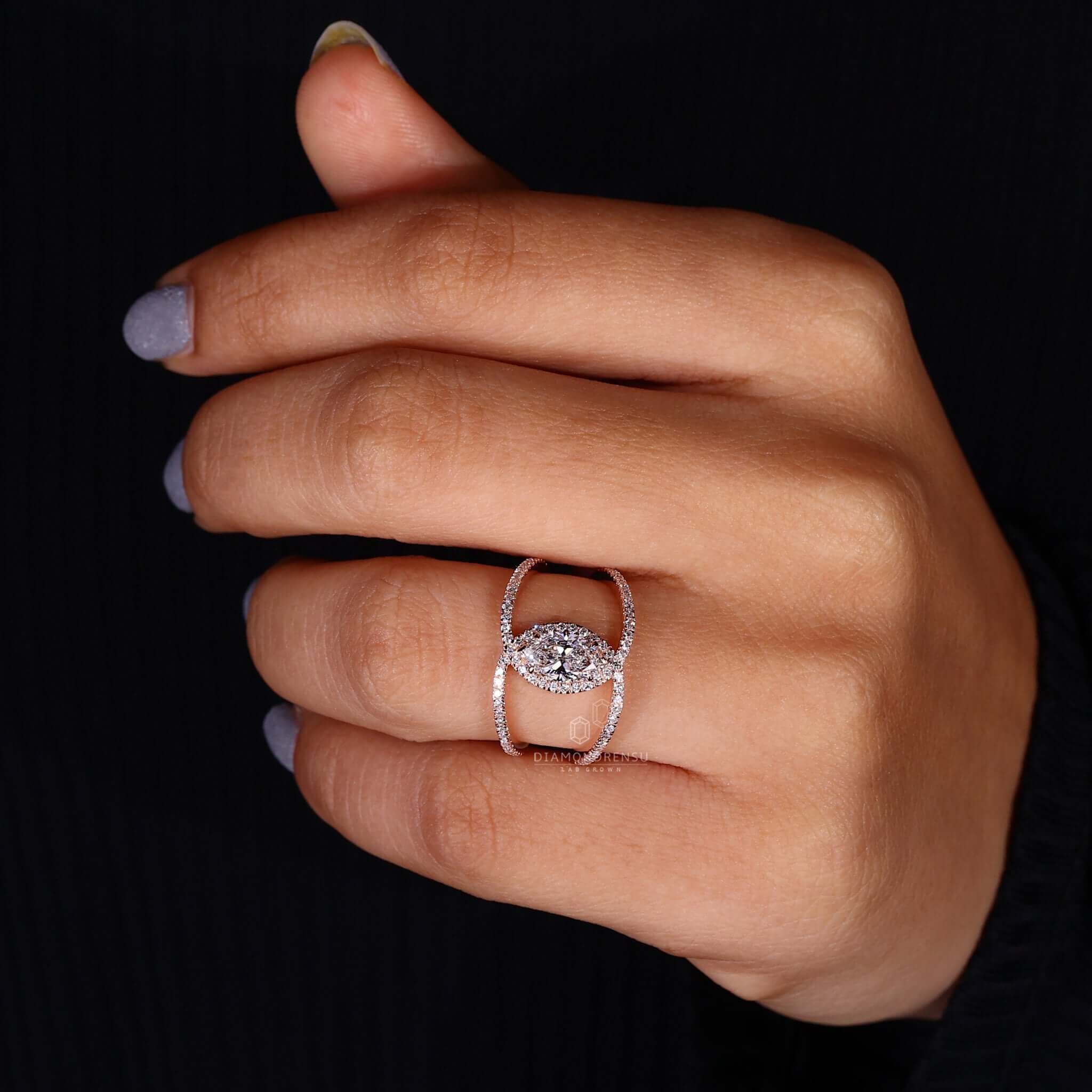 Engagement ring with pave design featuring a claw prong ring and rose gold finish.