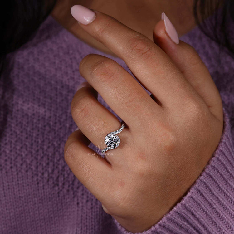 Round diamond engagement ring crafted with a unique bypass ring design for timeless elegance.
