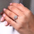 Halo style ring with cushion center in rose gold.
