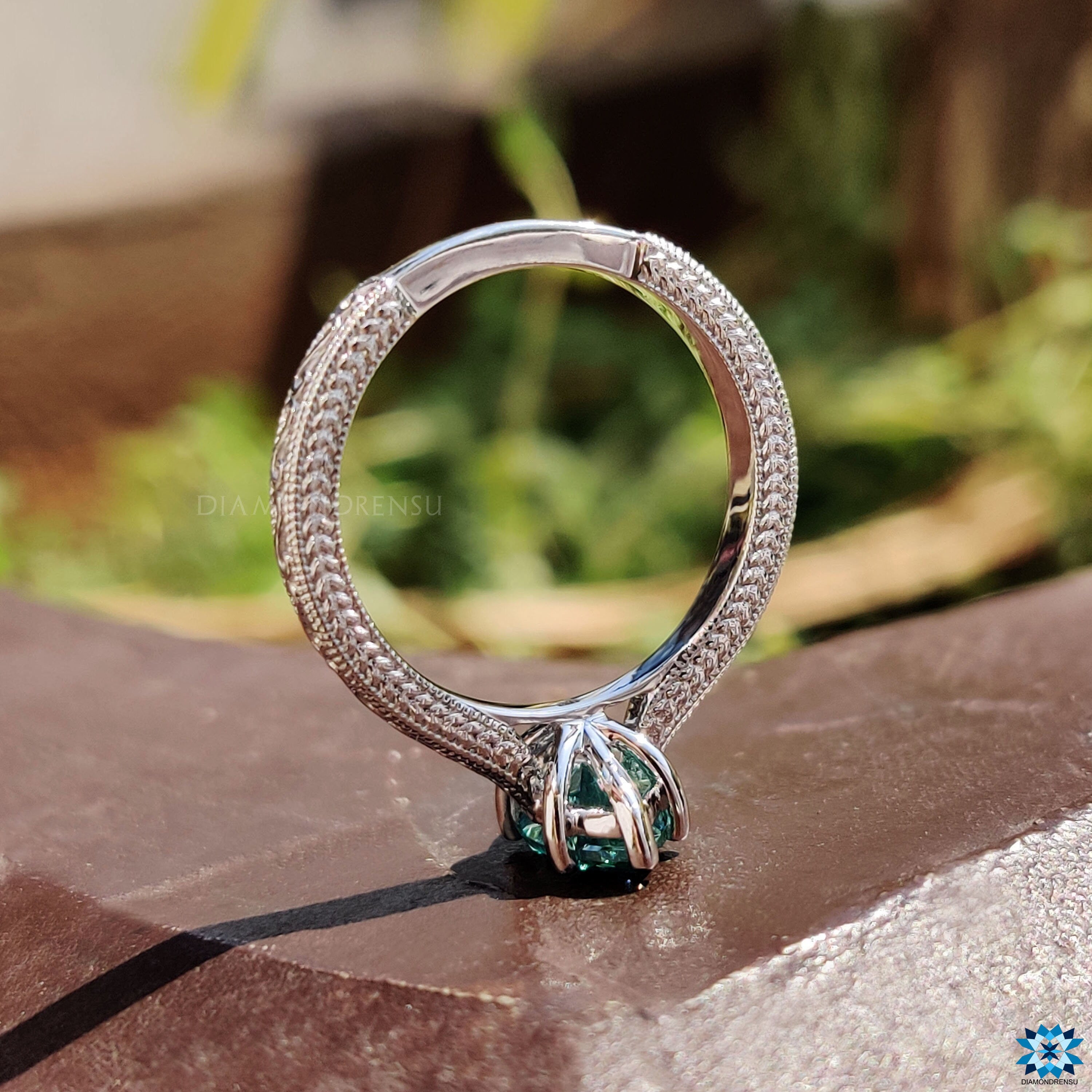 Unique marquise moissanite solitaire ring in white gold with milgrain edge finish.
