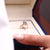 V prong setting ring holding a sparkling diamond.
