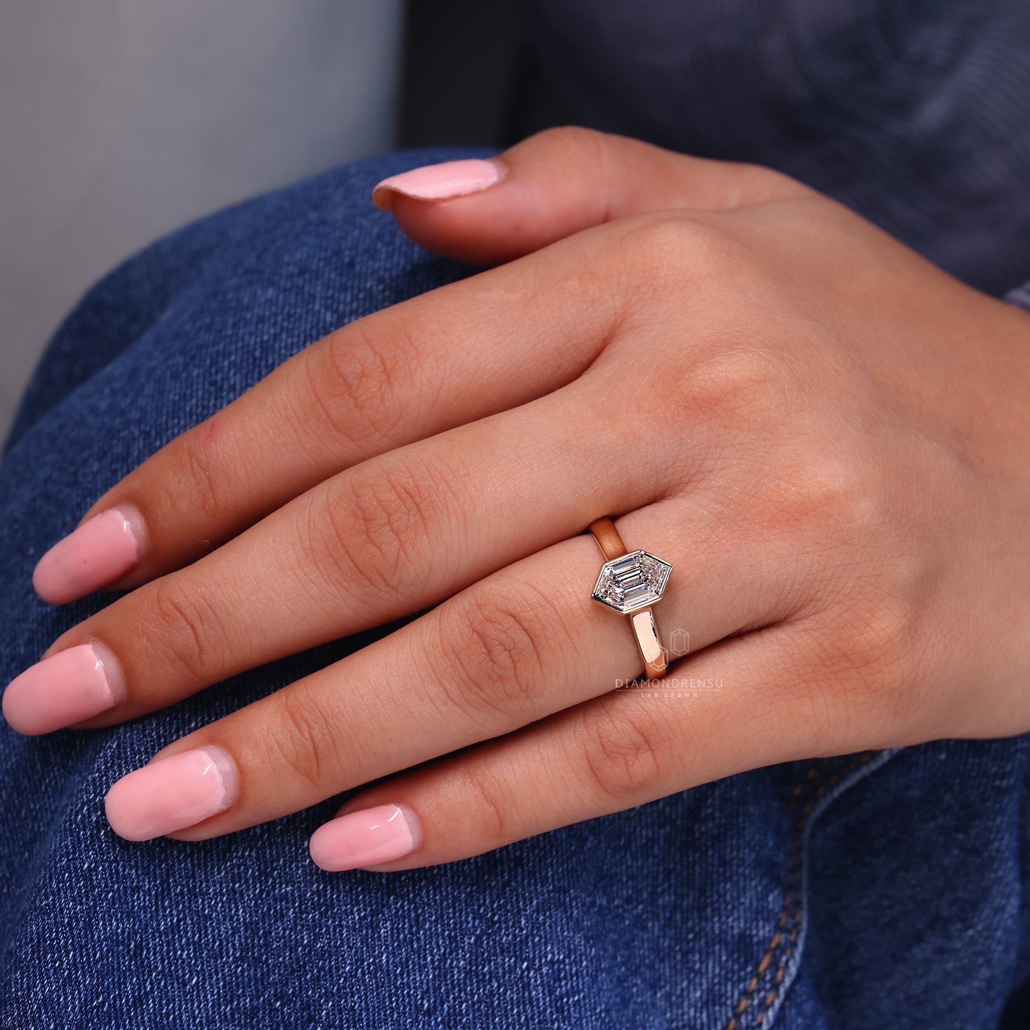 Yellow gold diamond ring with hexagon cut center.
