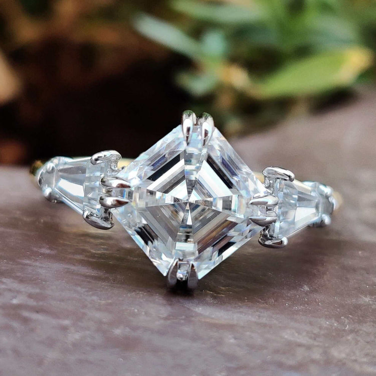 Asscher cut moissanite engagement ring with tapered baguette sides.
