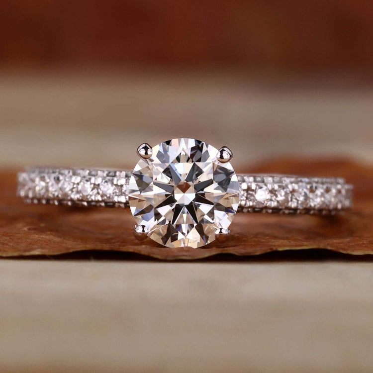 Pave diamond ring with a hidden halo design and three side pave setting for a timeless engagement ring.
