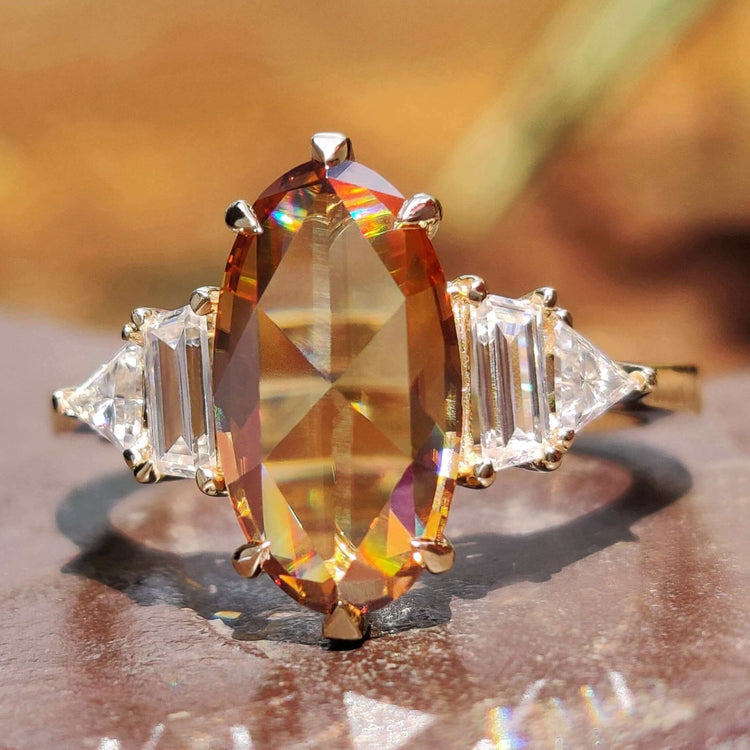 Champagne moissanite ring with 5 stone design.
