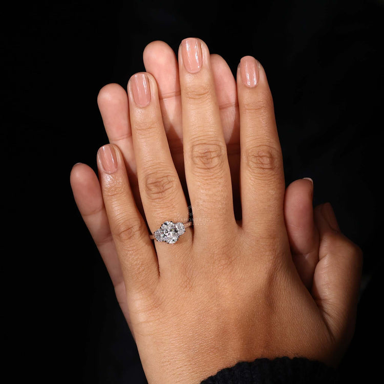Oval engagement ring featuring a 3 stone engagement ring style with two half moon side stones for added sparkle.

