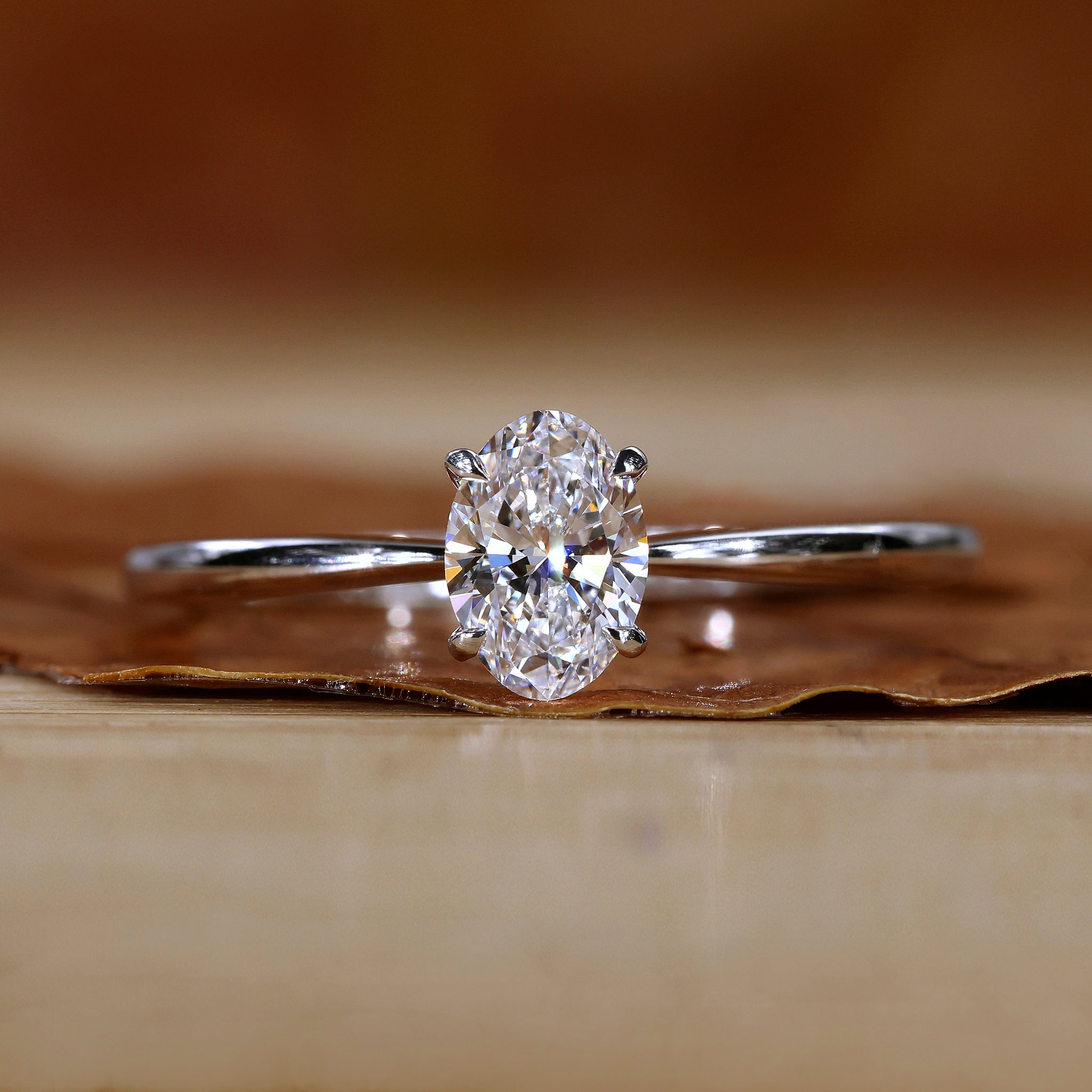 Oval solitaire engagement ring in white gold.
