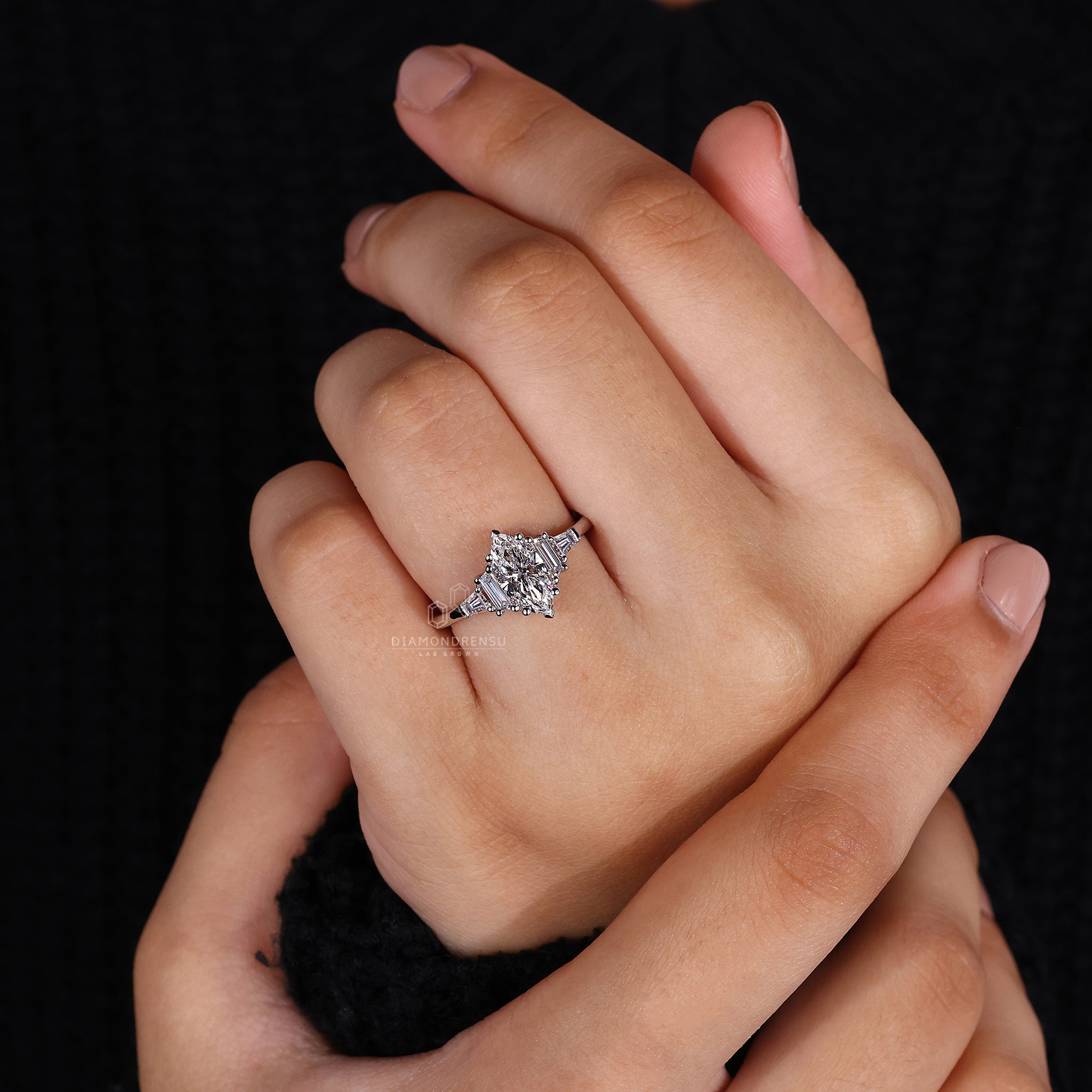 Tapered baguette cut ring and trapezoid cut ring are set in 5 stone ring design.
