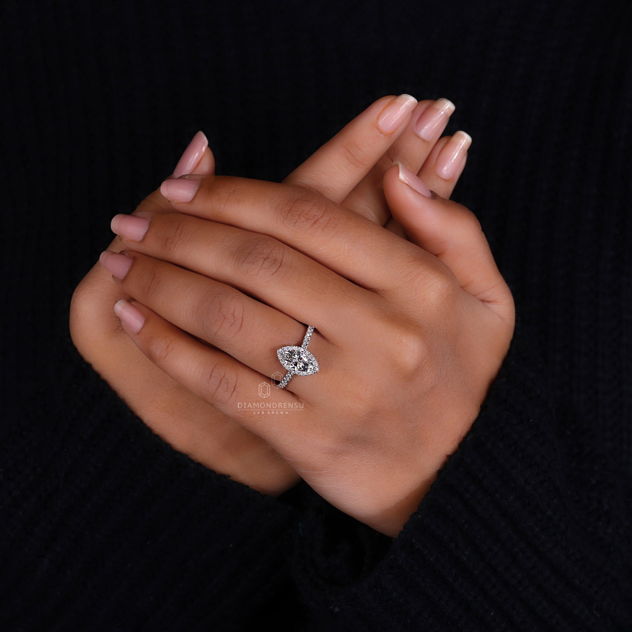 White gold ring with marquise and round halo design.
