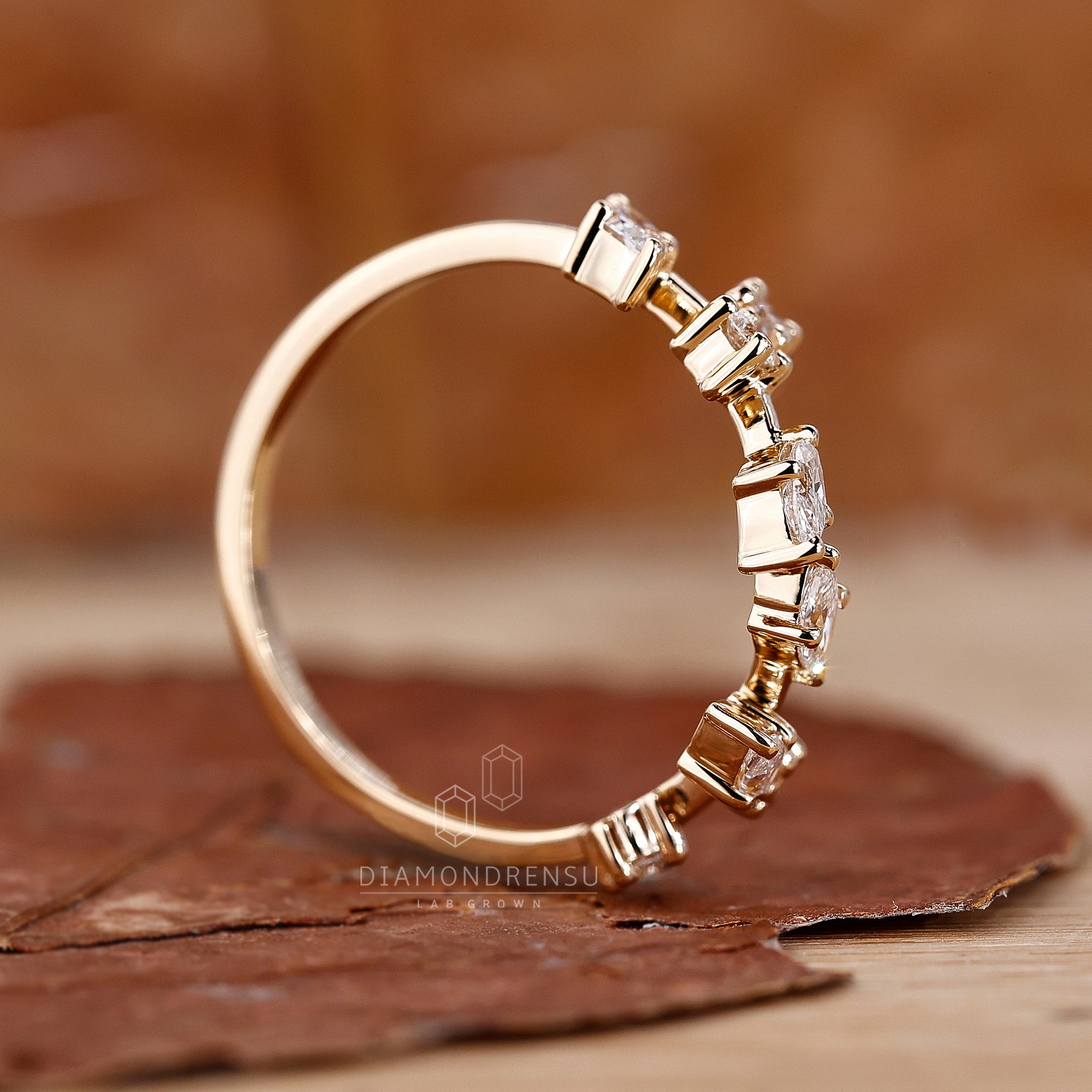 Gold wedding band with lab-grown diamonds, featuring a nature-inspired design