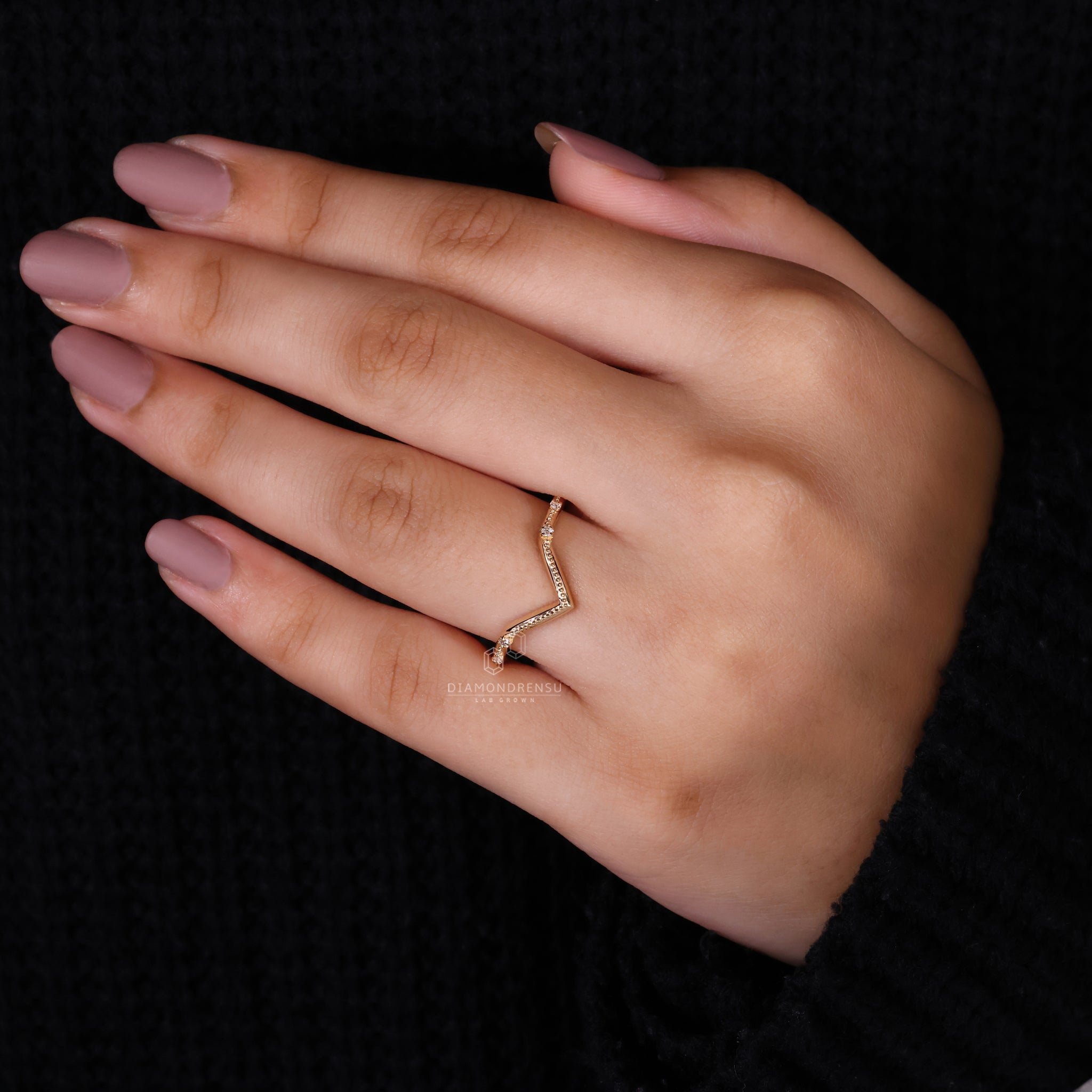 Curved wedding band with round cut diamonds.
