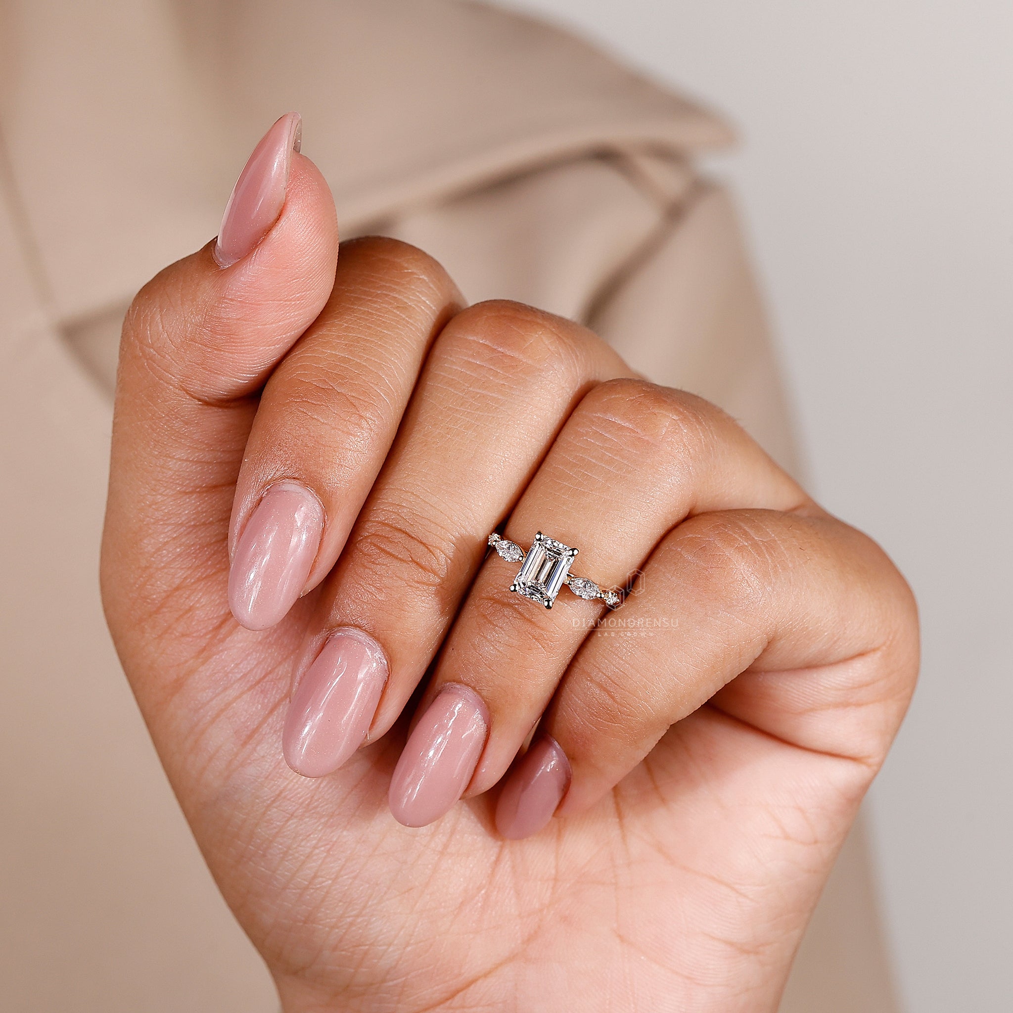 UK engagement ring with prong set emerald diamond and yellow gold band.
