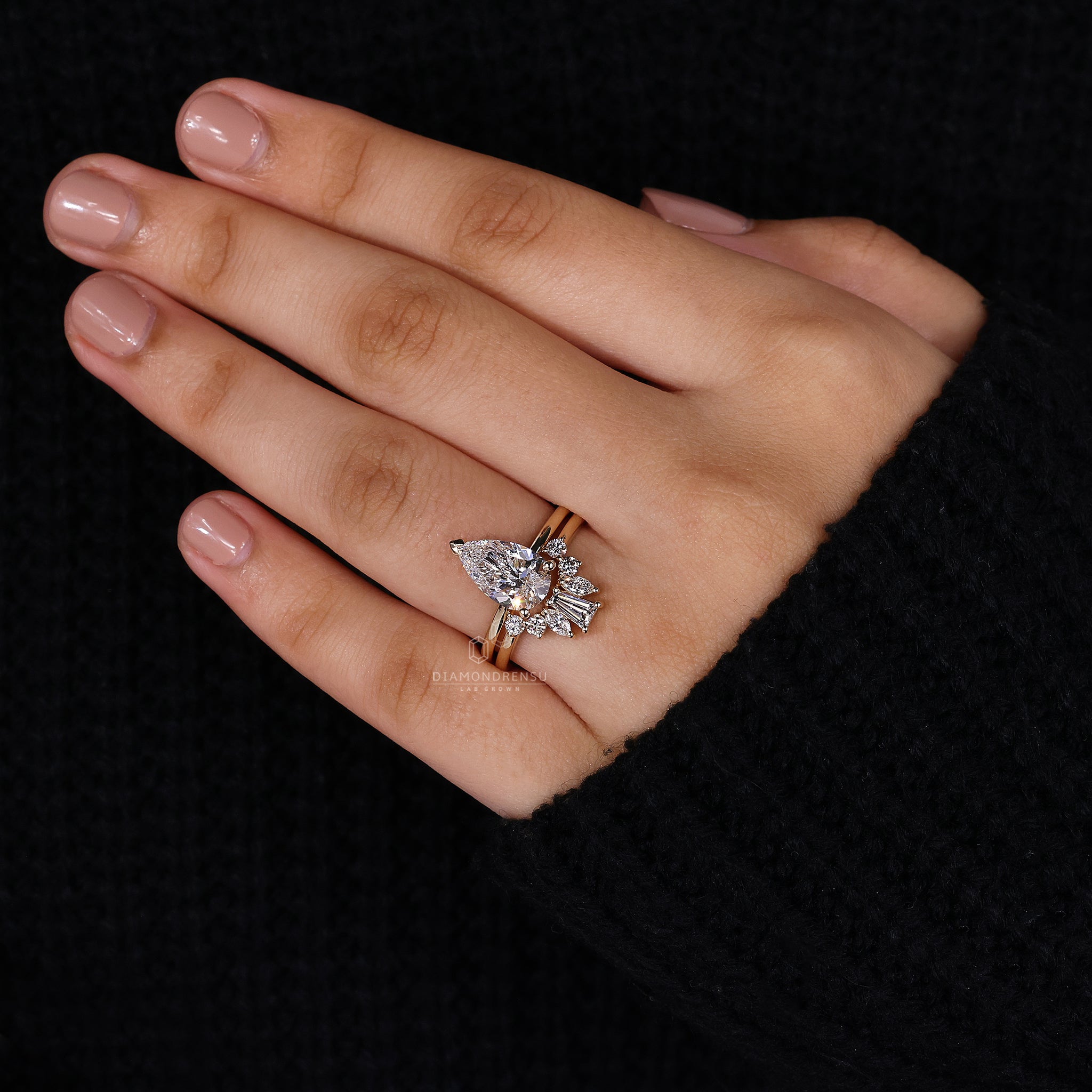 Crown wedding band paired with pear ring.
