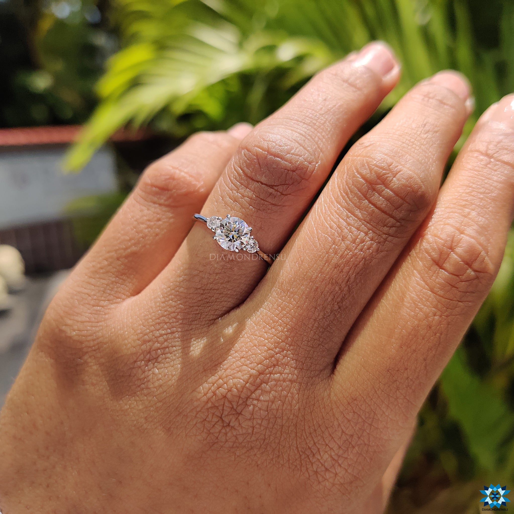 White gold engagement ring featuring 3 stone round moissanite setting.
