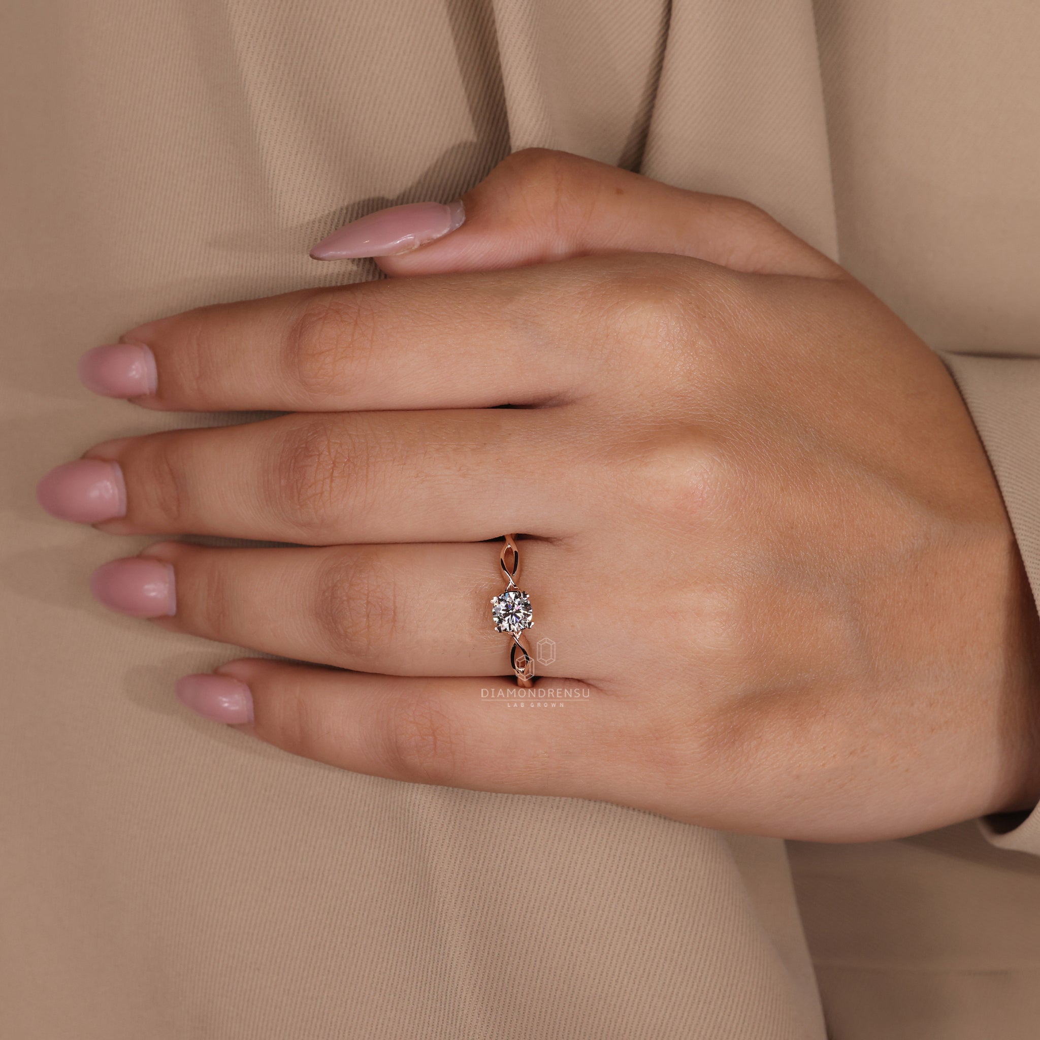 Diamondrensu UK engagement ring with twisted shank and round diamond centre.

