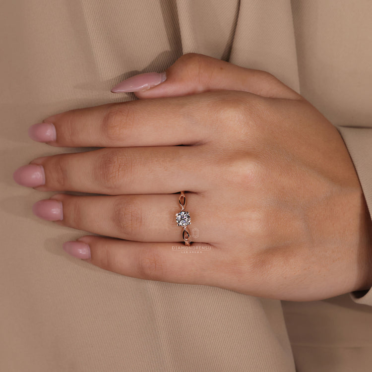 Diamondrensu UK engagement ring with twisted shank and round diamond centre.

