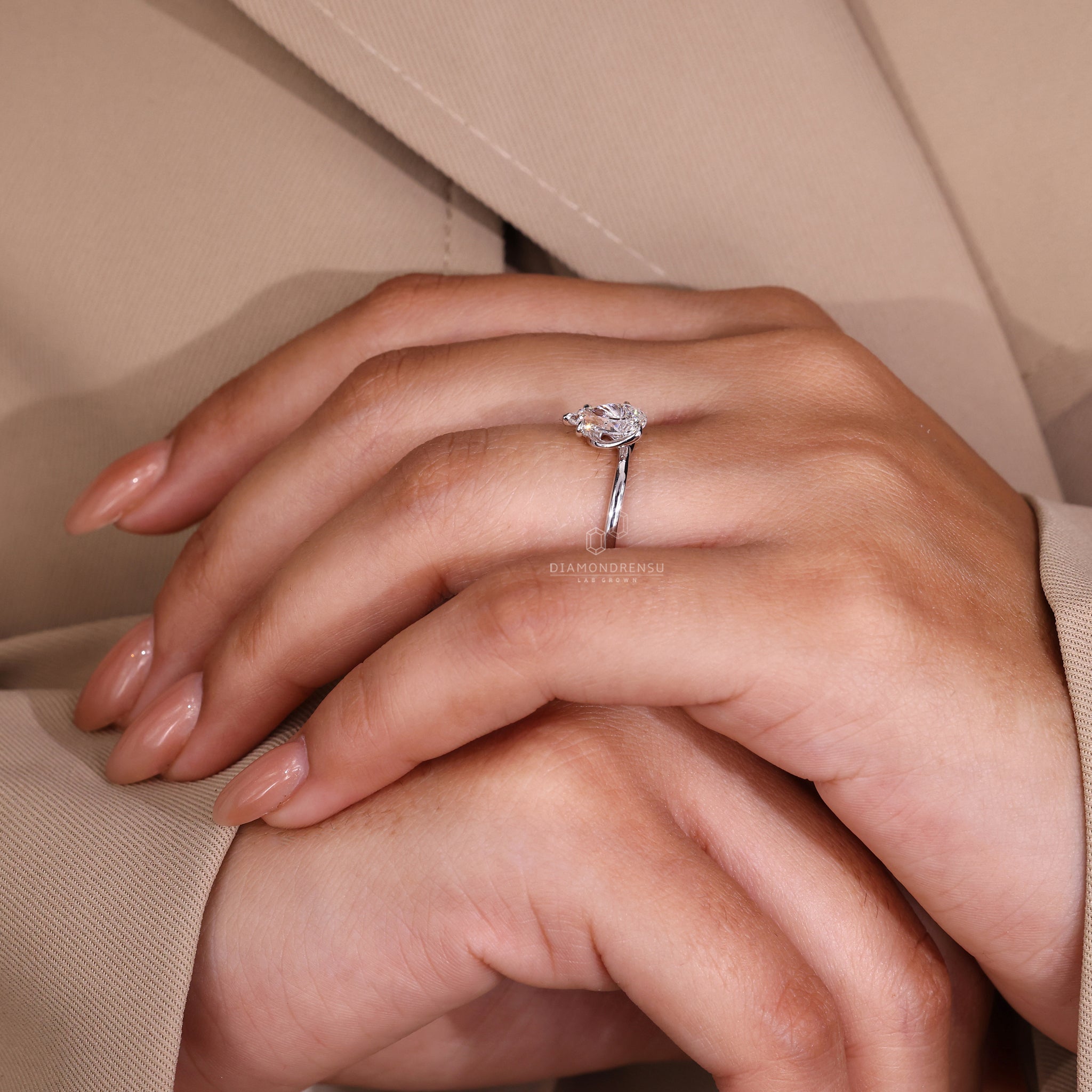 White gold engagement ring featuring a twisted prong setting.
