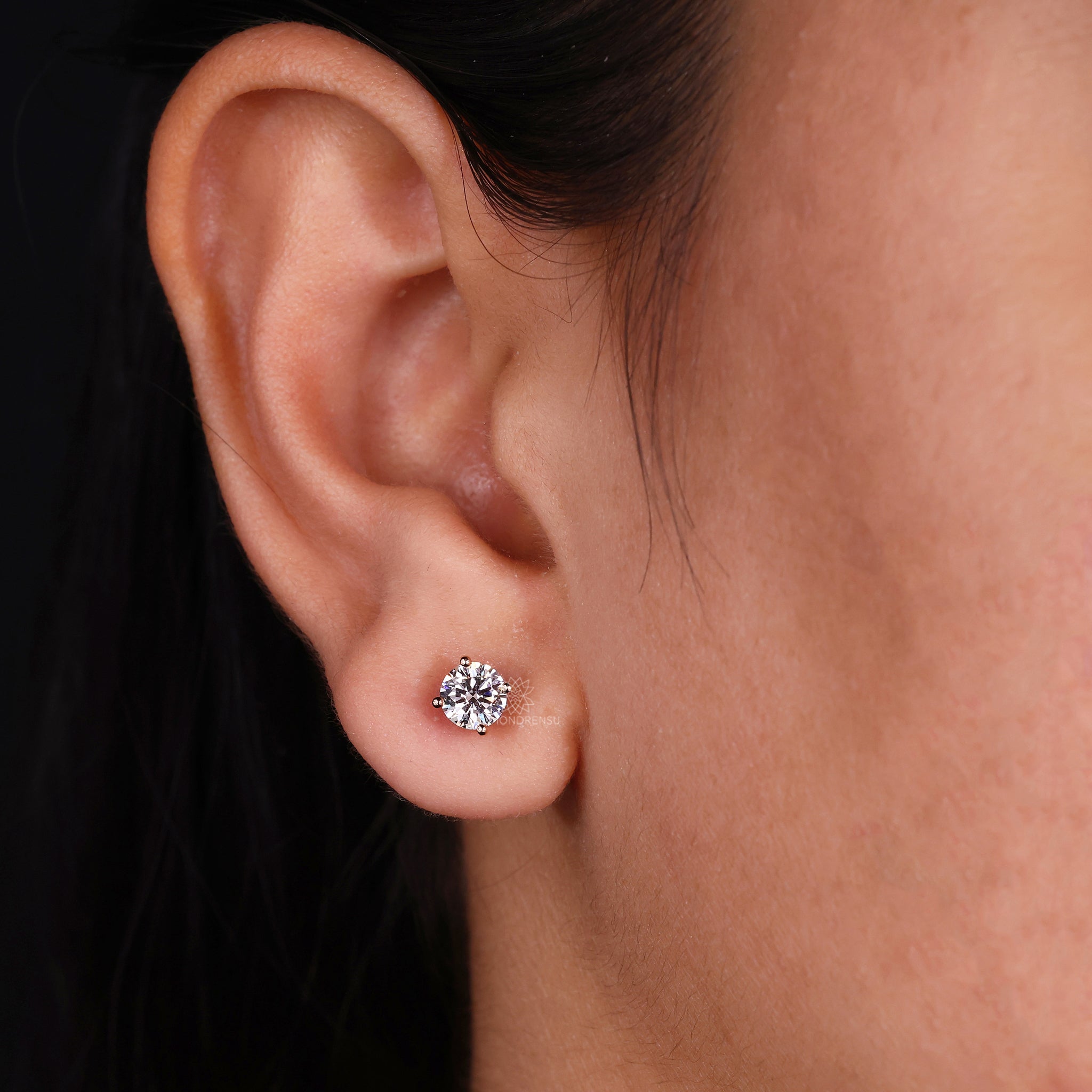 Diamond stud earrings UK featuring round cut stones in rose gold.