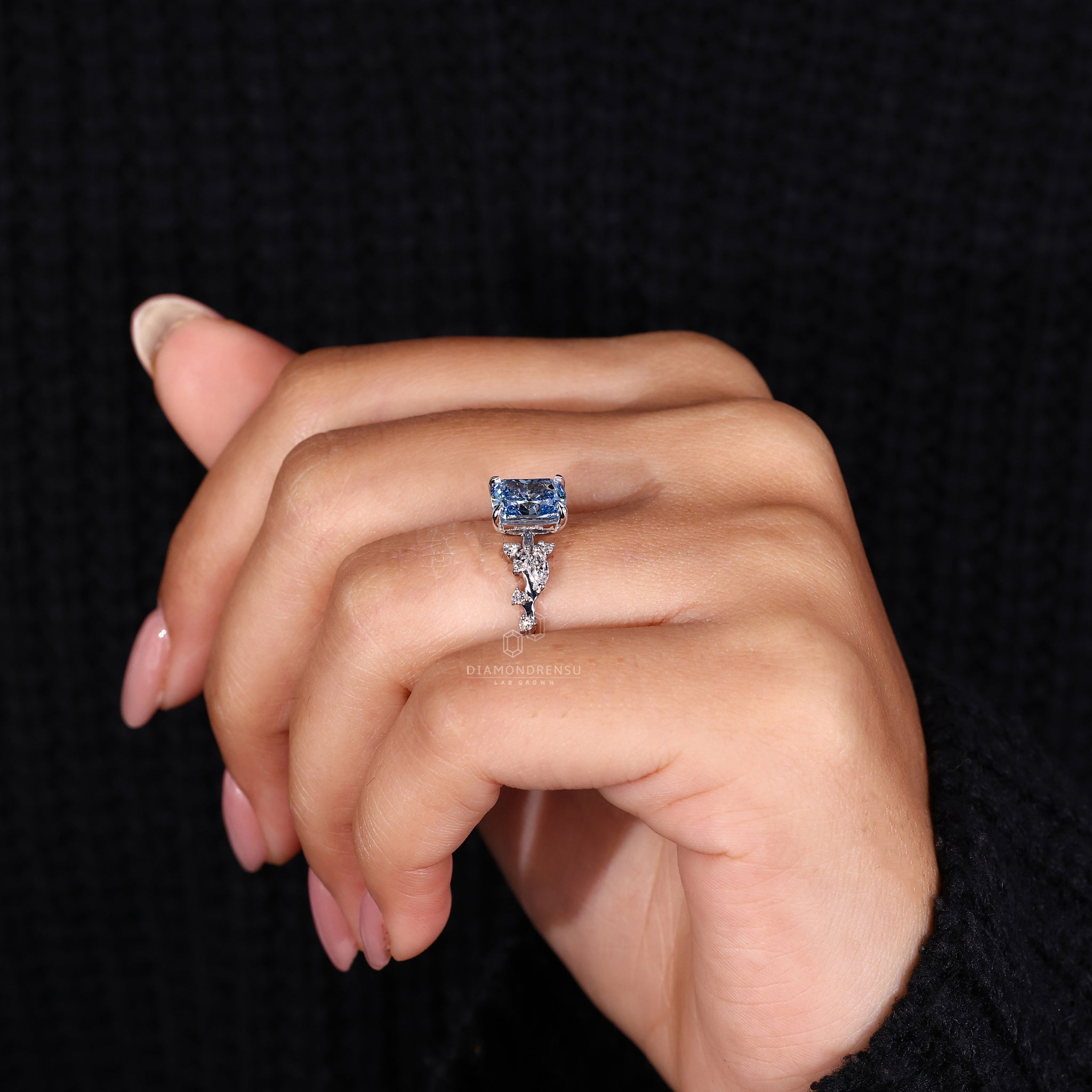 Buy engagement ring featuring IGI certified blue diamond and side stones.
