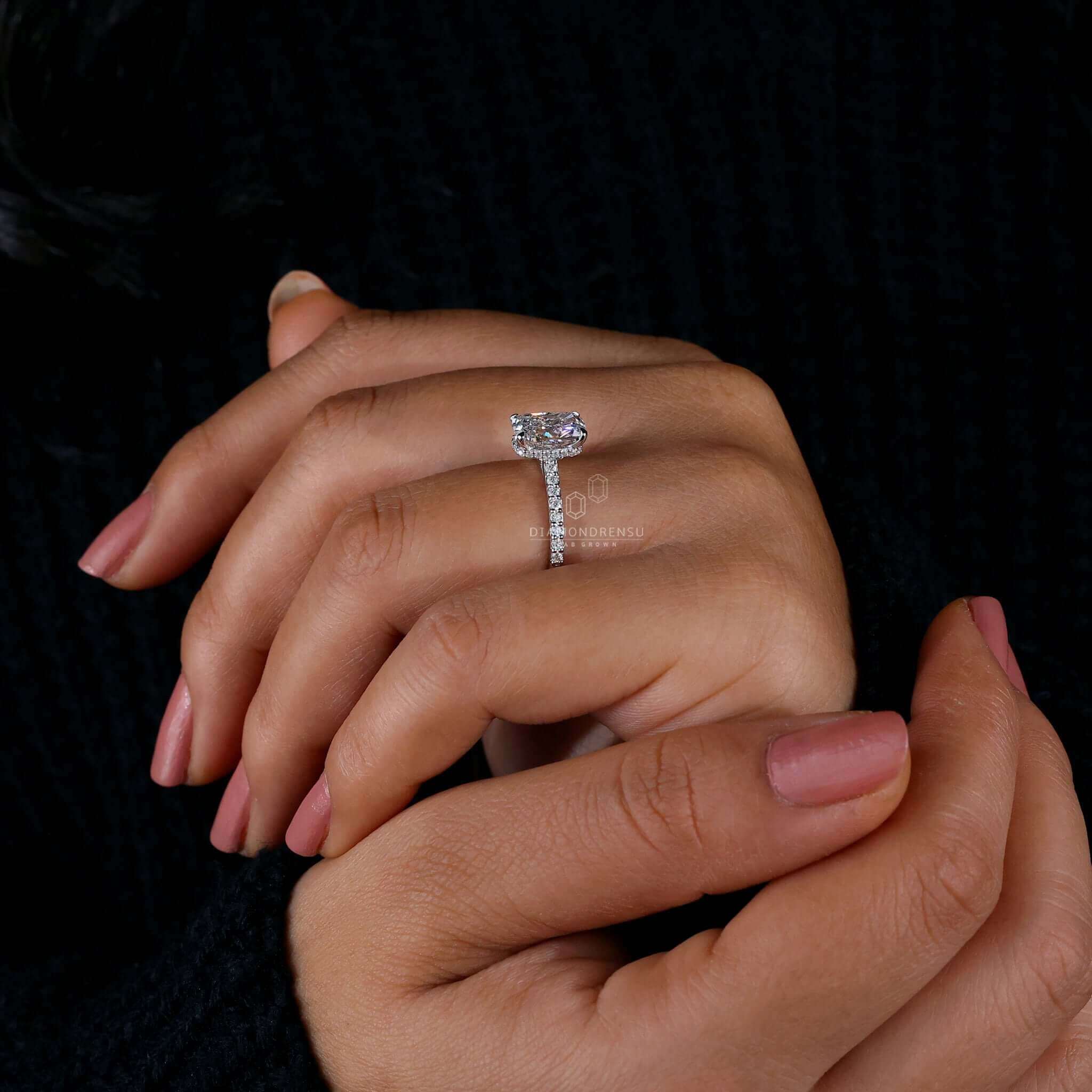 White gold engagement ring featuring a cushion cut diamond and 4 prong claw setting.