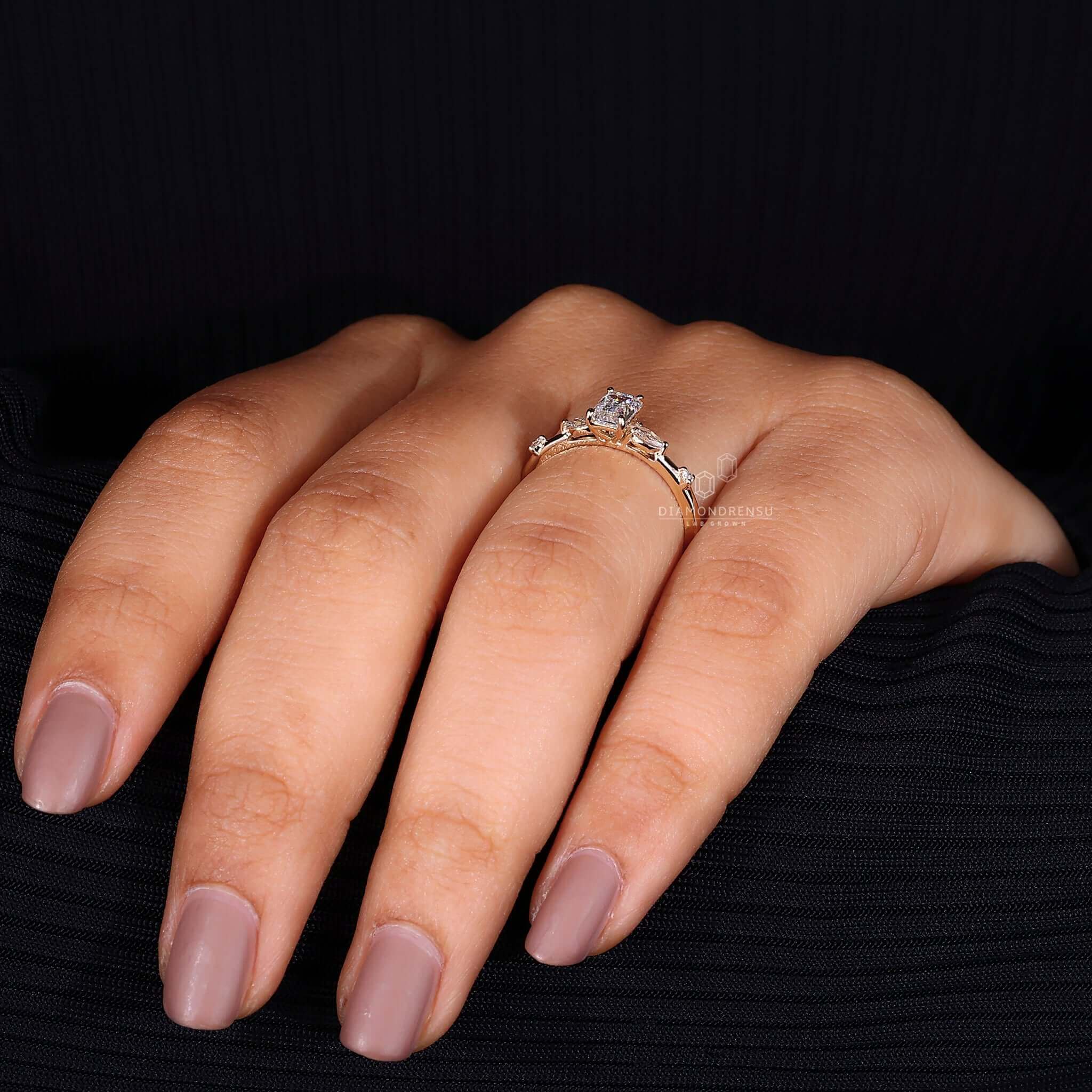 Diamond ring with marquise side stones, crafted for elegance and style.