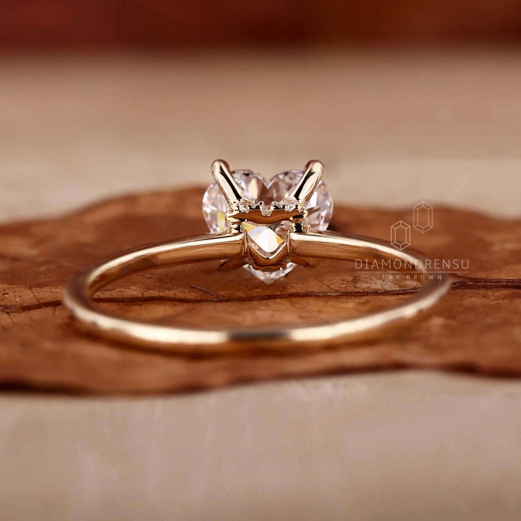Claw prong ring crafted as a yellow gold engagement ring with a hidden halo ring design.