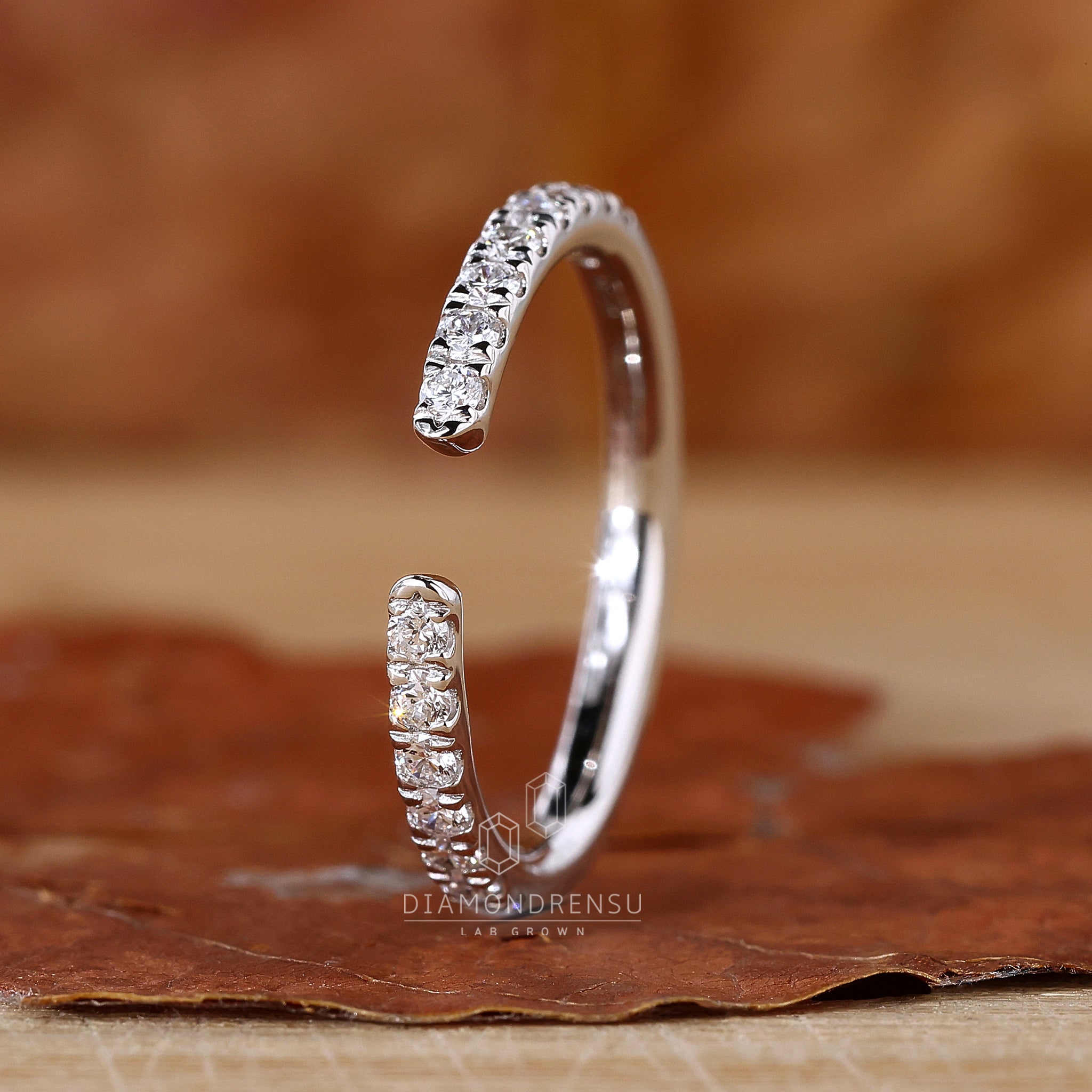 Open band wedding ring with round diamonds.
