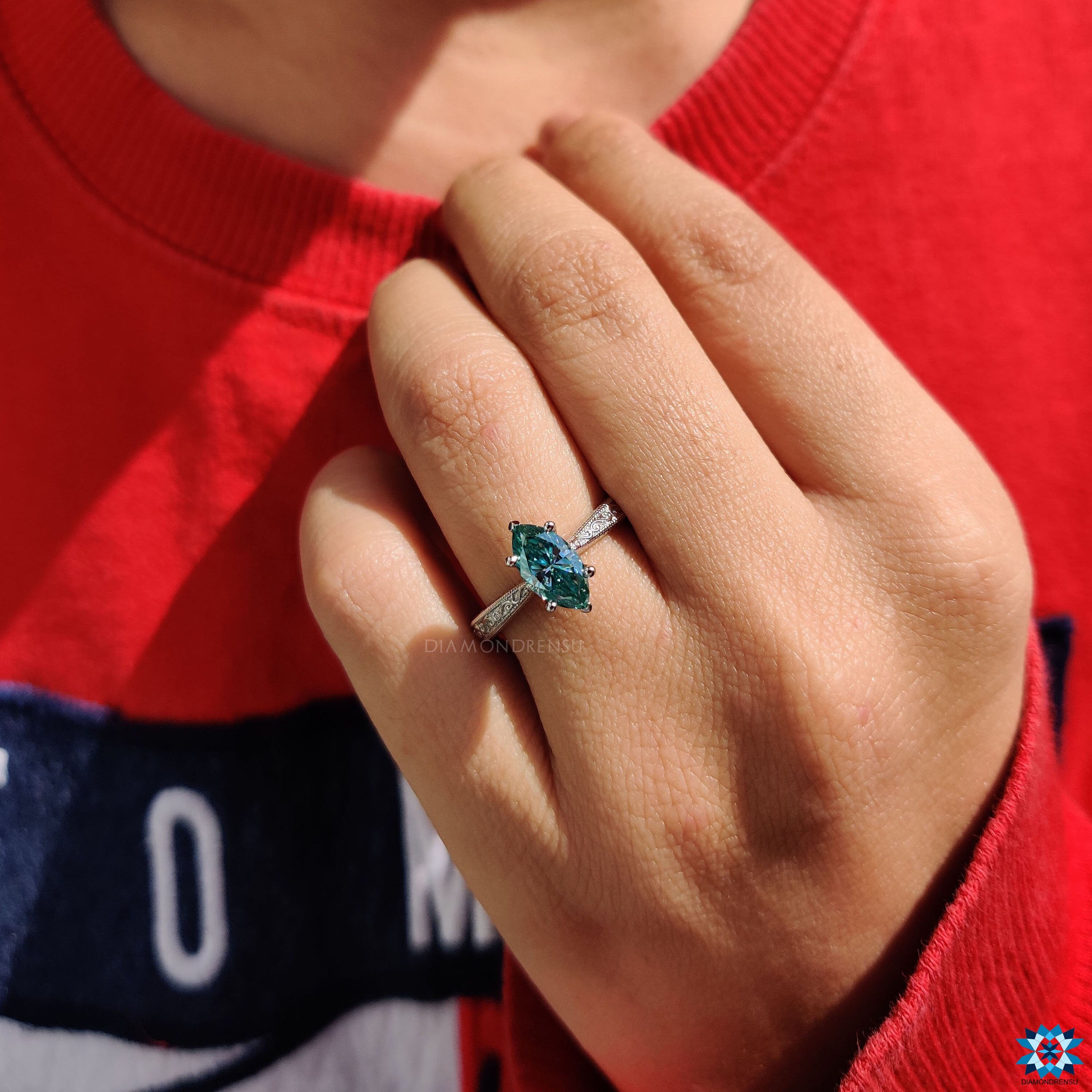 Handmade Art Deco engagement ring with marquise moissanite in milgrain setting.
