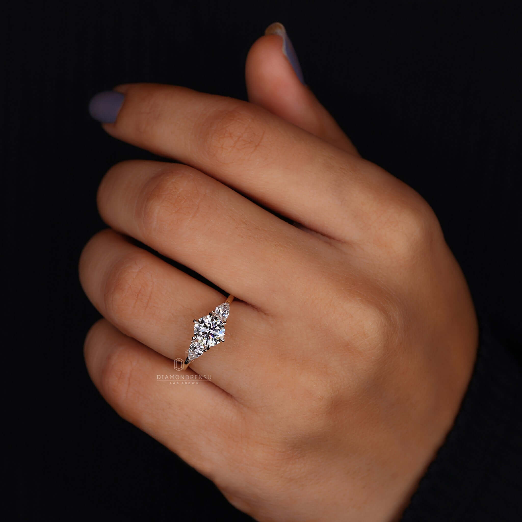 A charming diamond ring with pear side stones, crafted to perfection.