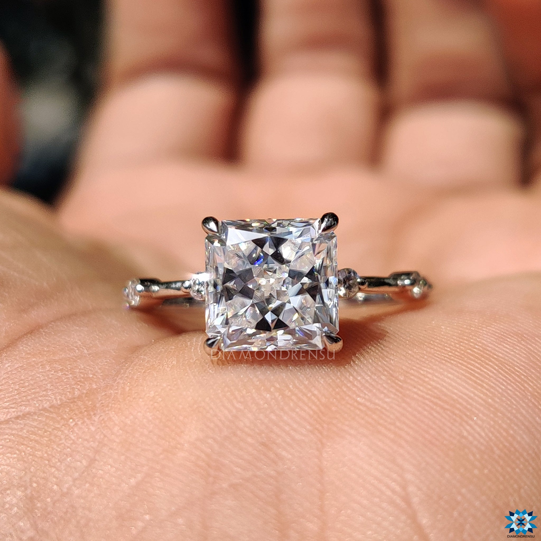 Round cut pave band with radiant moissanite in white gold setting.
