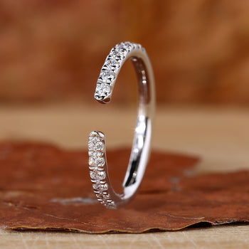 Open wedding band with round diamonds.
