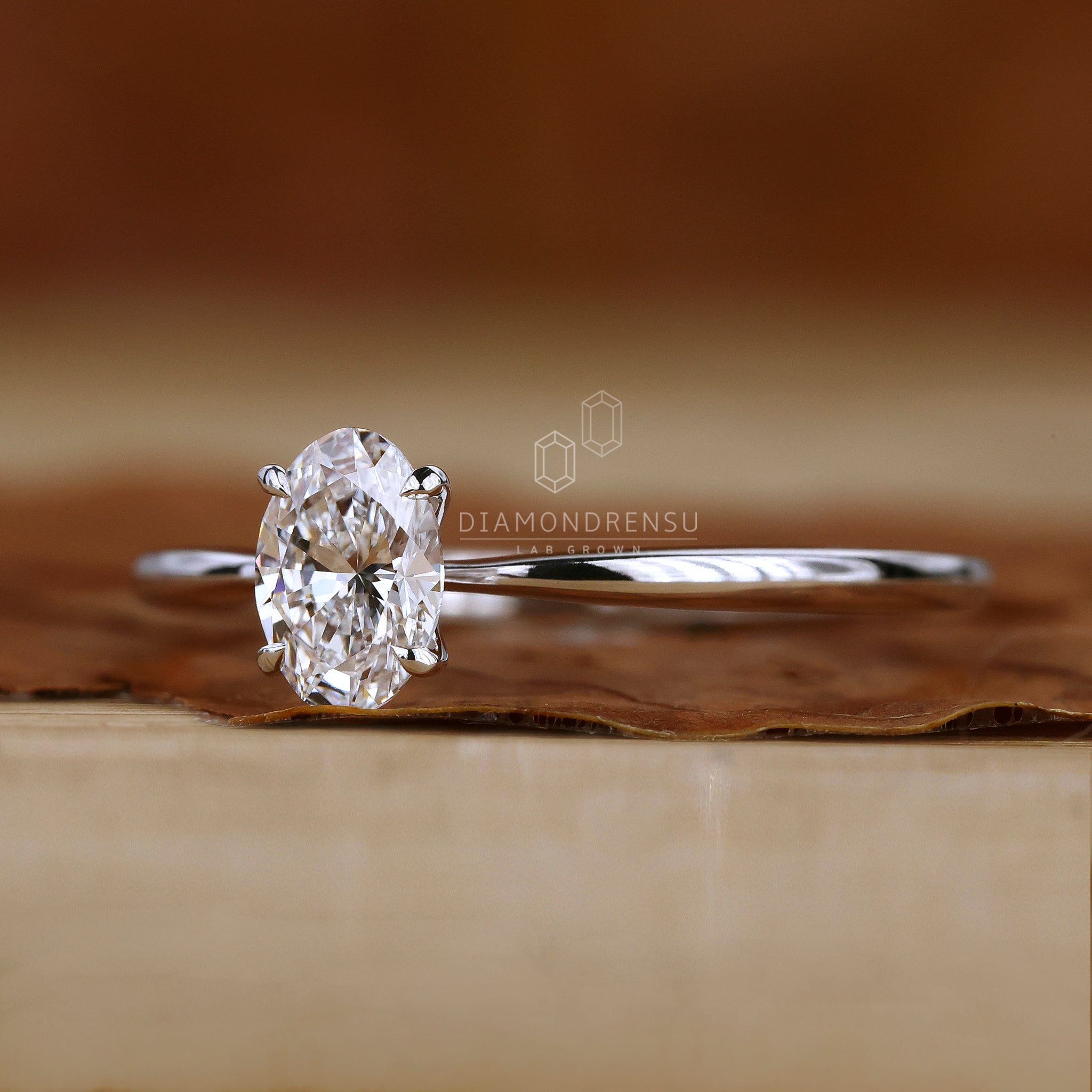 Tapered shank ring with oval solitaire stone.
