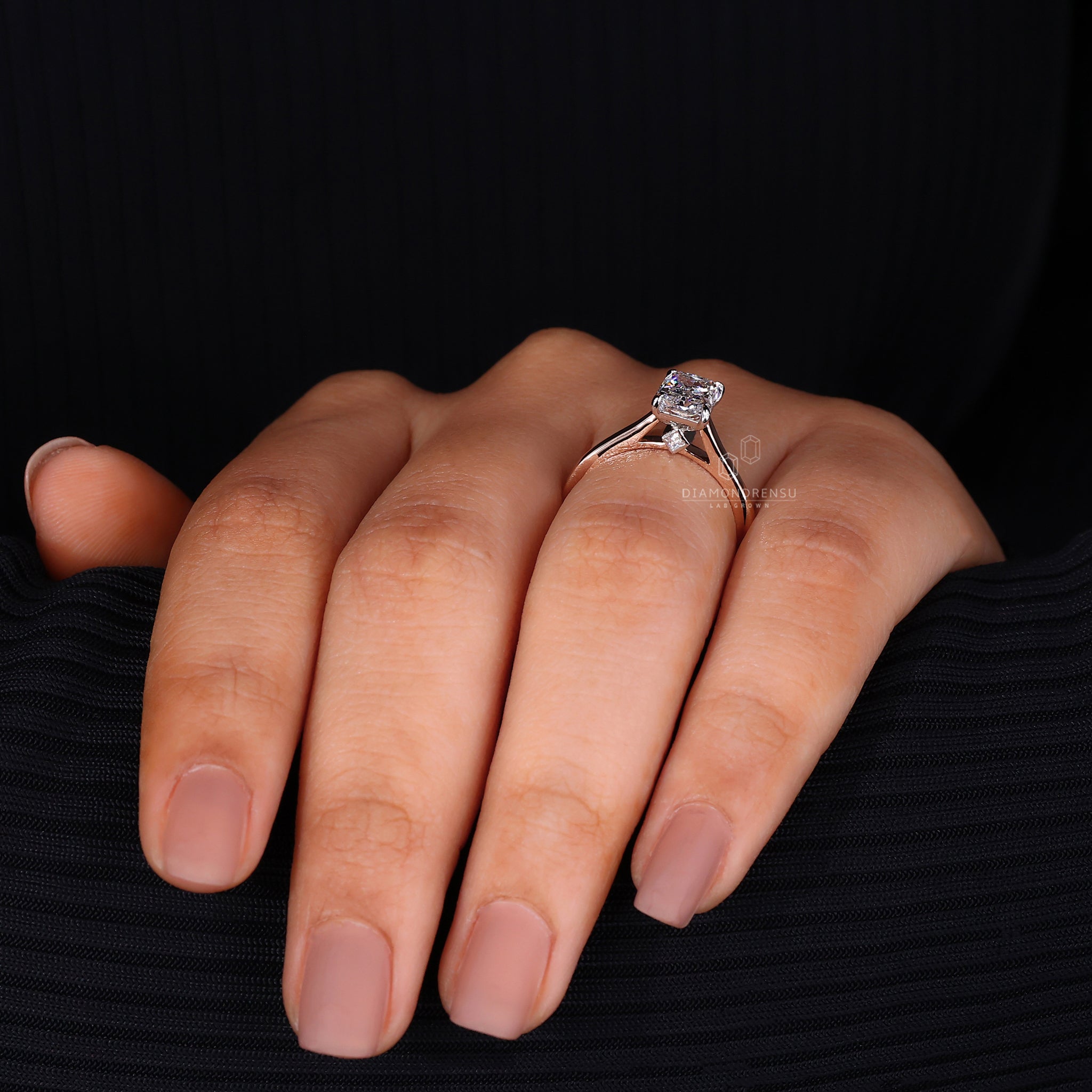 Two tone metal engagement ring with radiant cut.

