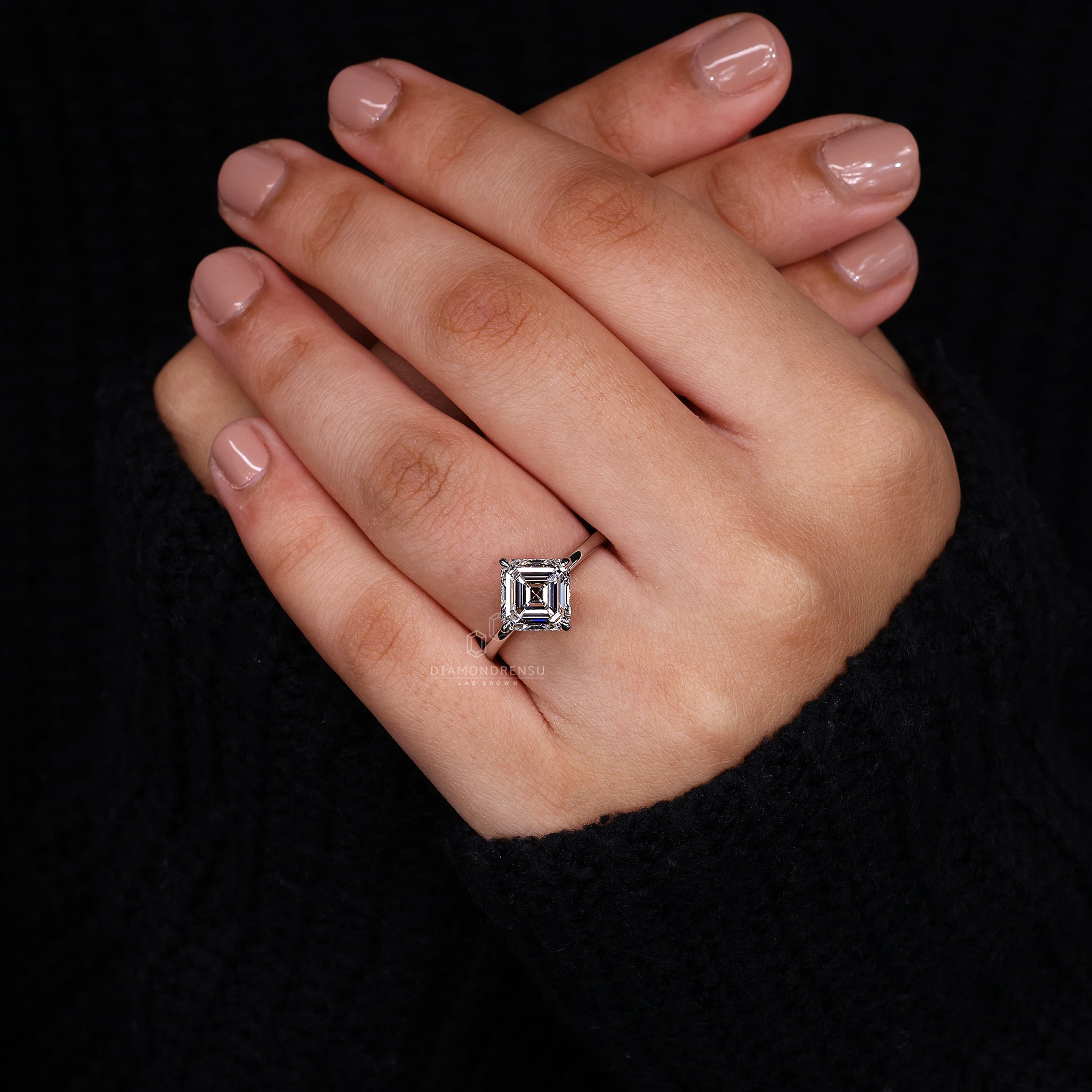White gold ring and compass prong hold the asscher diamond in prong setting.
