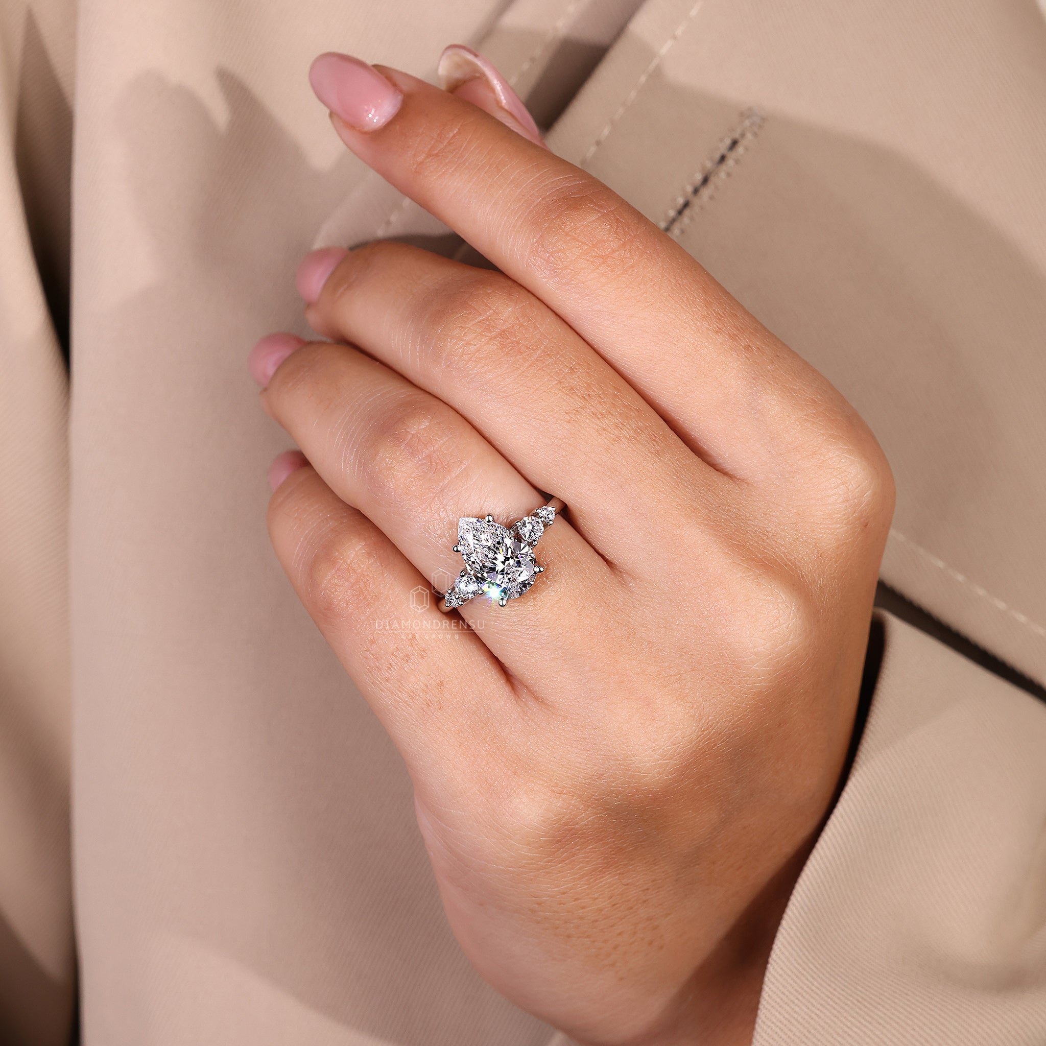 Handmade jewellery ring featuring white gold band and five stone design.
