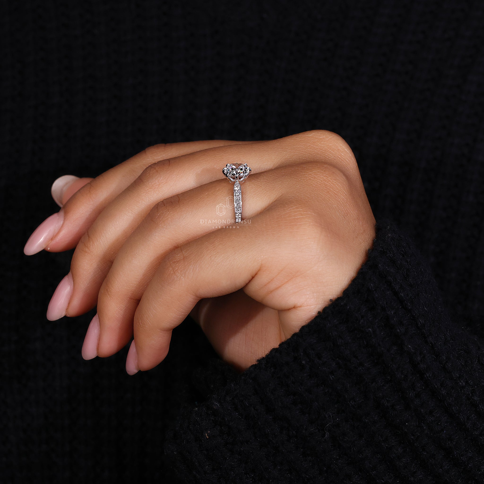 Custom engagement ring in white gold with pave band and cushion old mine cut.
