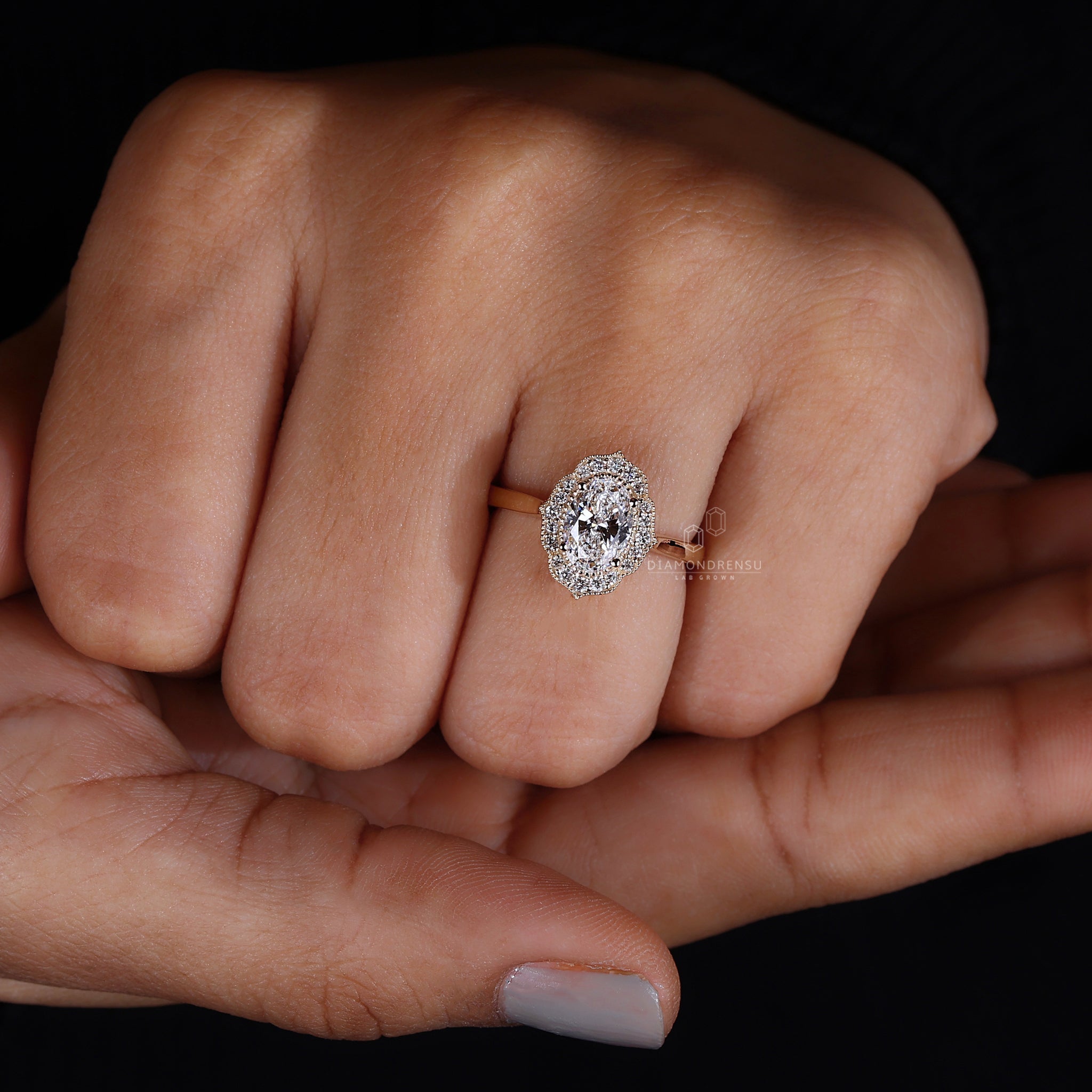 Oval halo engagement ring with a dazzling centre stone surrounded by a halo.