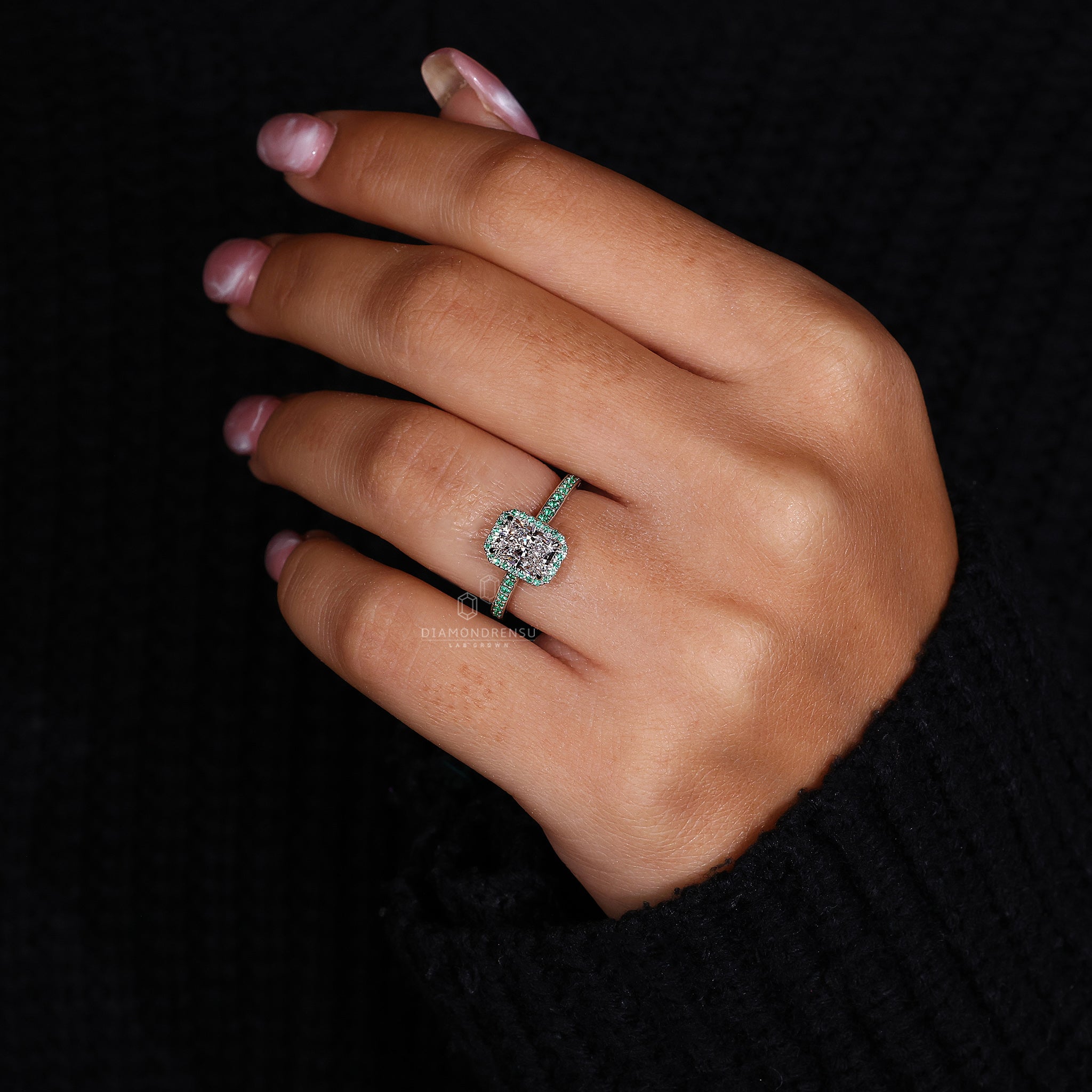 Unique engagement ring featuring a green round lab diamond.
