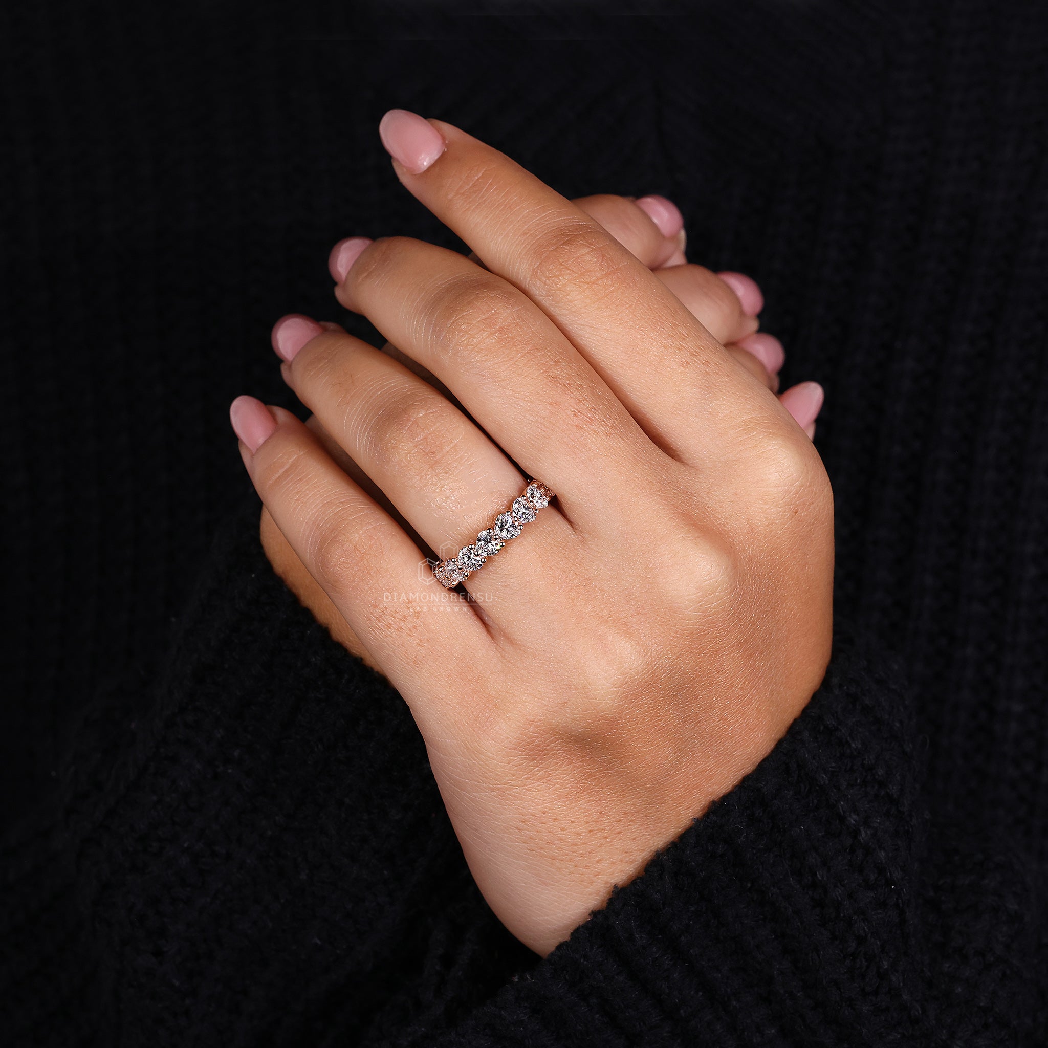 Rose gold wedding ring with heart diamonds.
