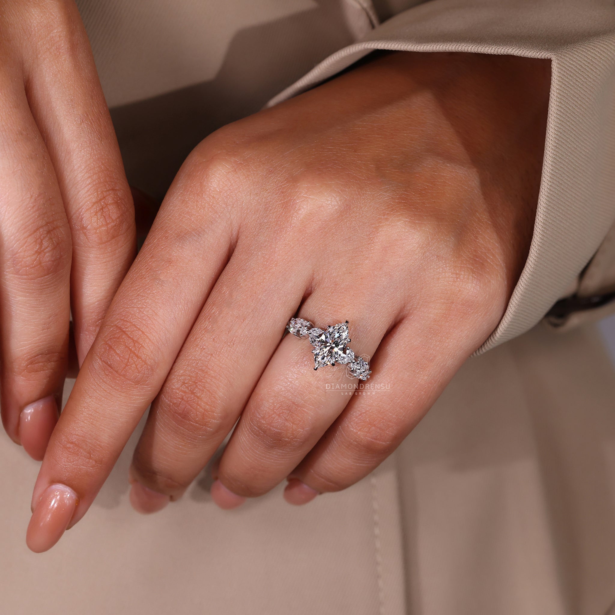 Lab diamond ring featuring marquise side diamond and round accents.
