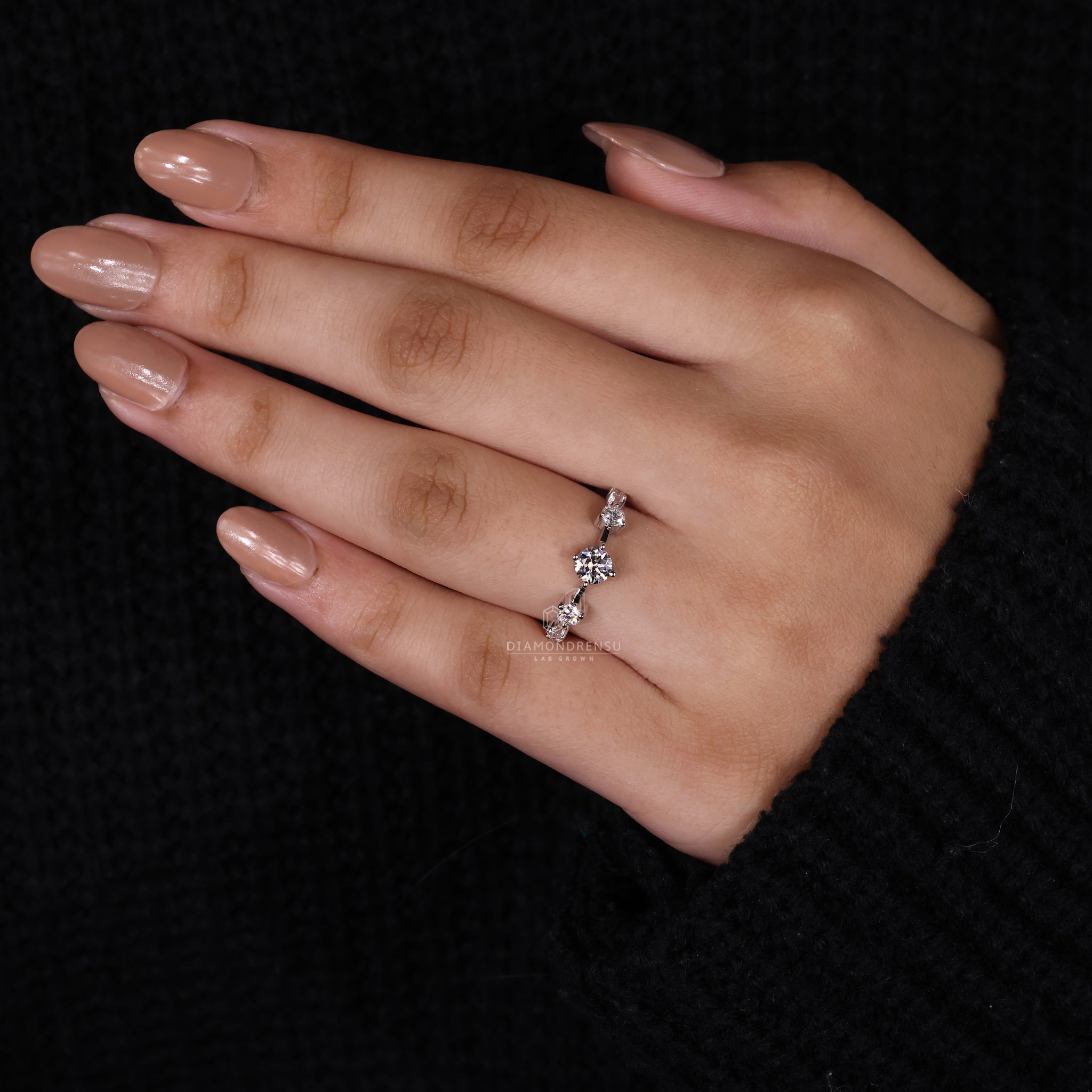 Round diamond engagement ring with side stone setting.
