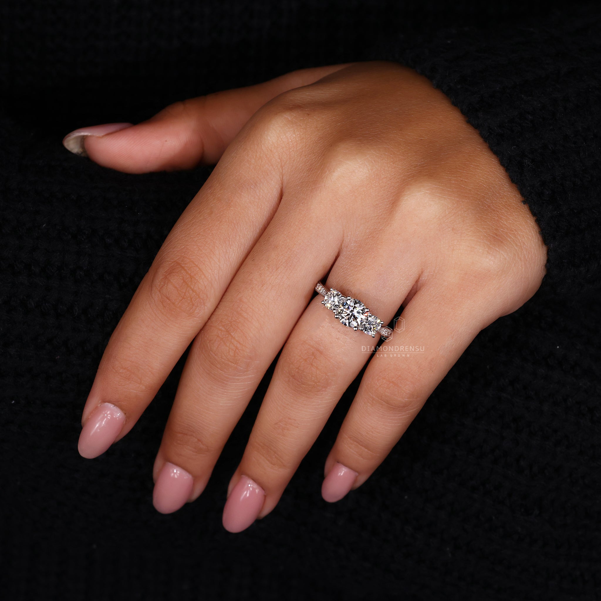 Diamondrensu UK engagement ring featuring round diamond pave set band.

