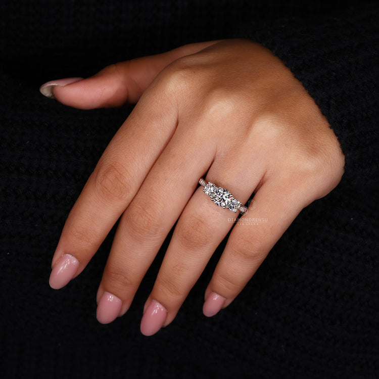 Diamondrensu UK engagement ring featuring round diamond pave set band.

