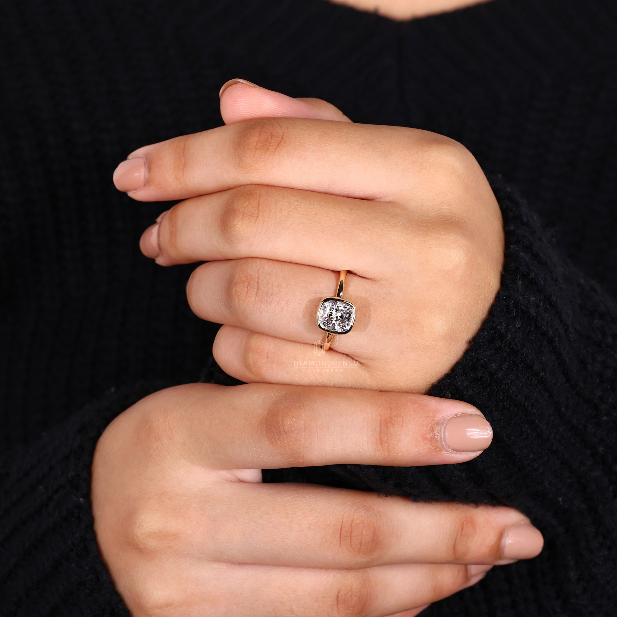 UK engagement ring includes solitaire and cushion cut design in yellow gold.
