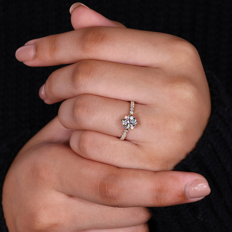 Lab diamond ring with prong set design and pave set band accents.
