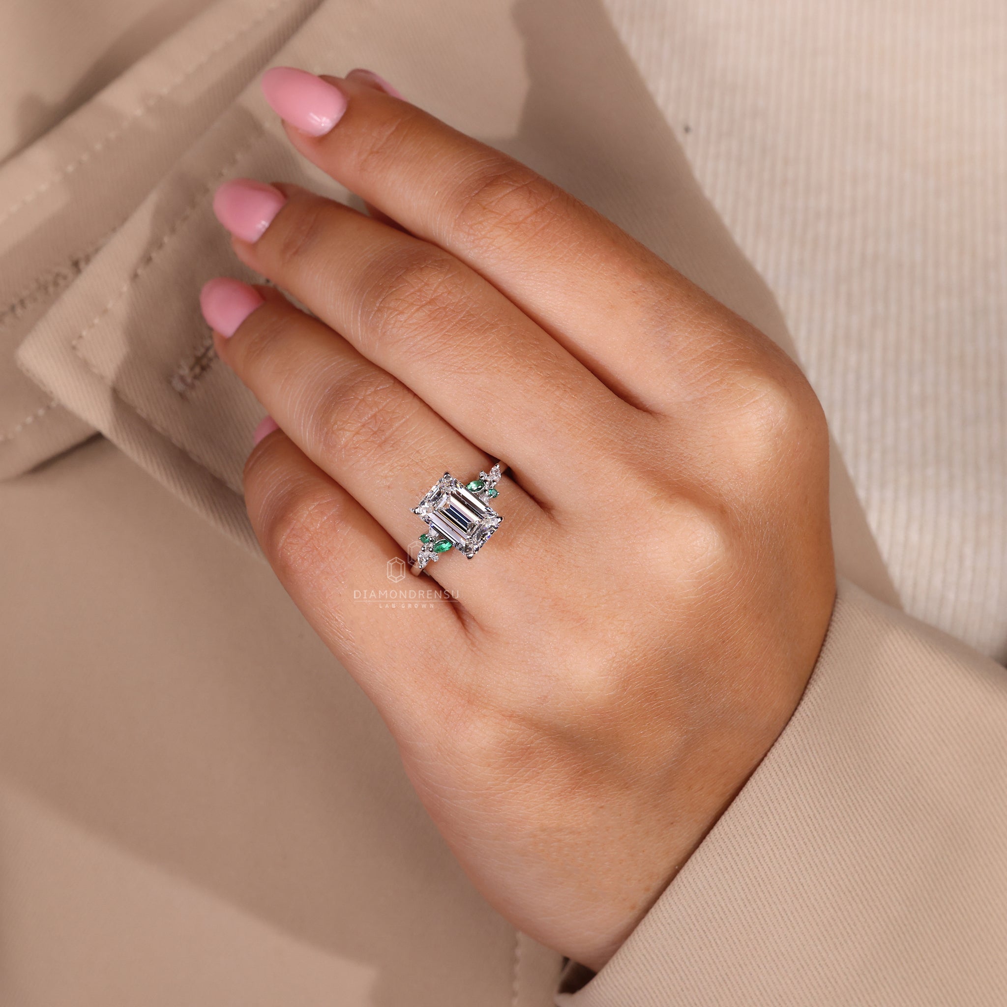 Lab grown diamond ring with prong setting and marquise side stones.
