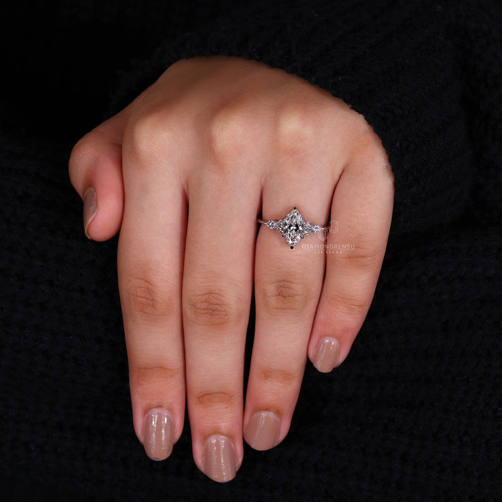Buy engagement ring with marquise and round side stones.

