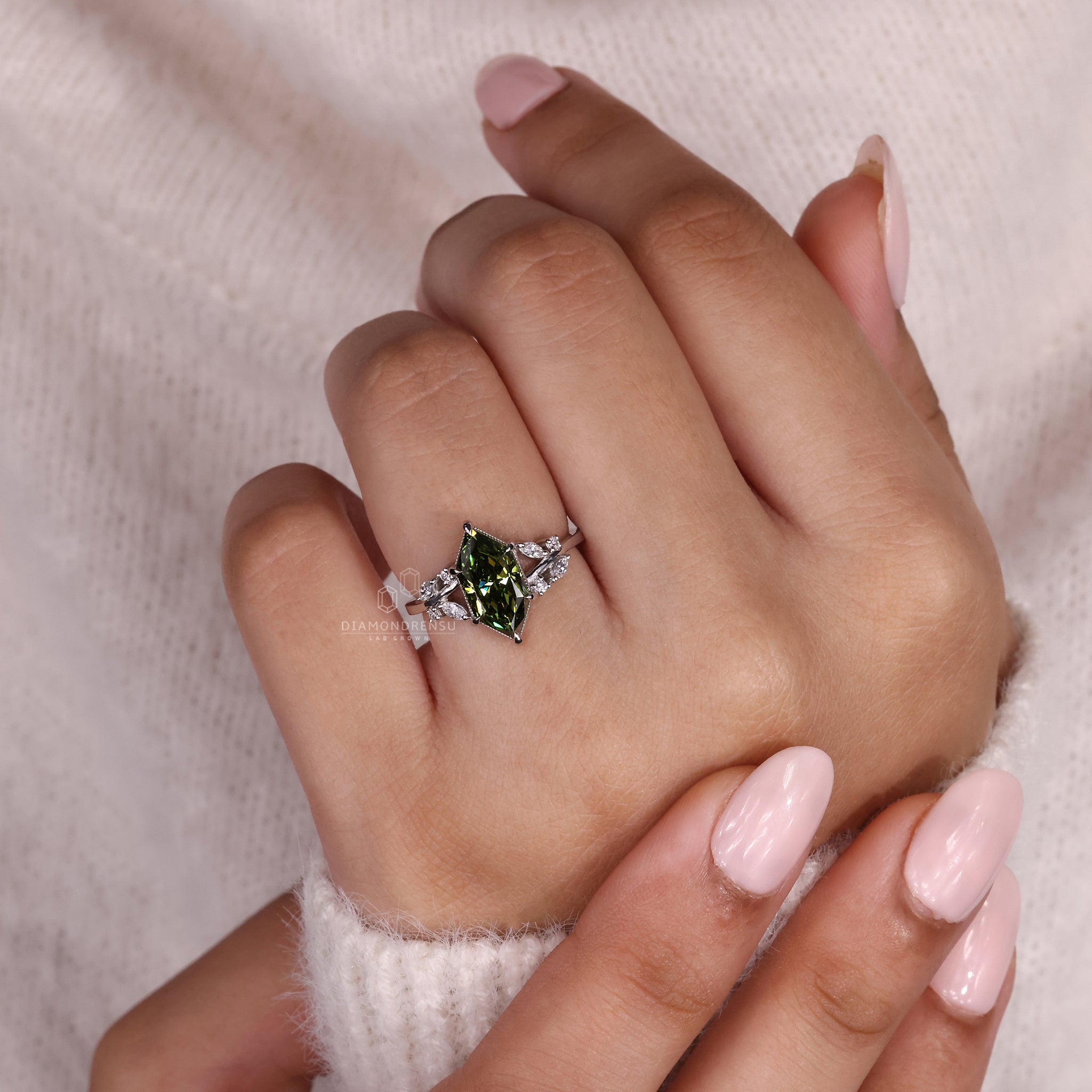 Marquise and round side stone ring in white gold.