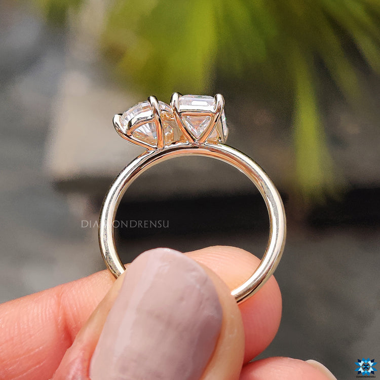 Pear and emerald cut ring with claw prongs
