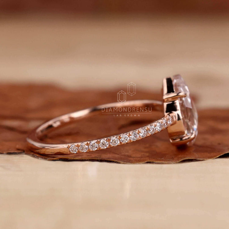 Pear shaped engagement ring with a stunning pave diamond ring setting for added brilliance.